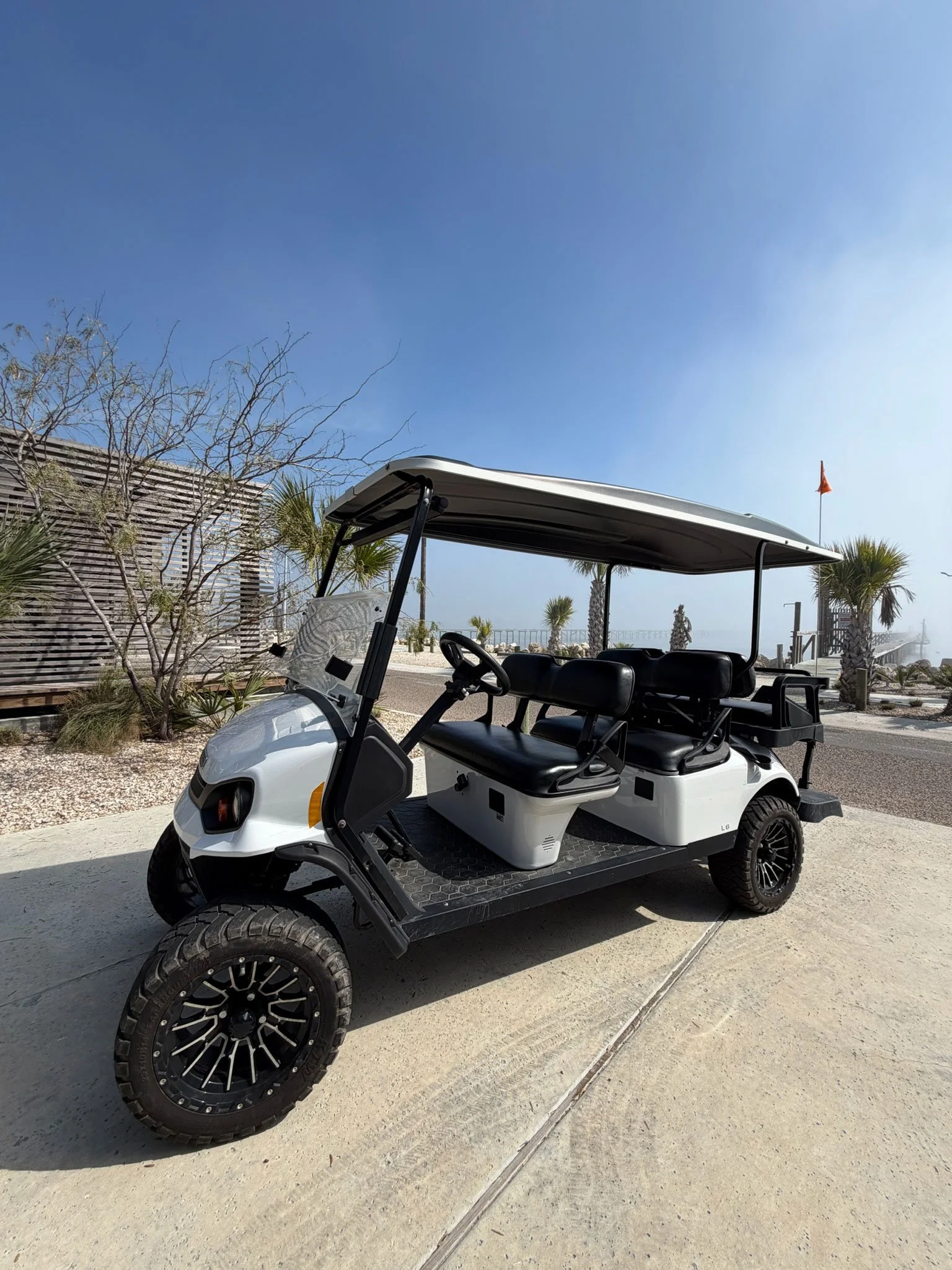 Golf cart for easy beach and boardwalk access, concierge amenity at a luxury Rockport TX vacation rental stay