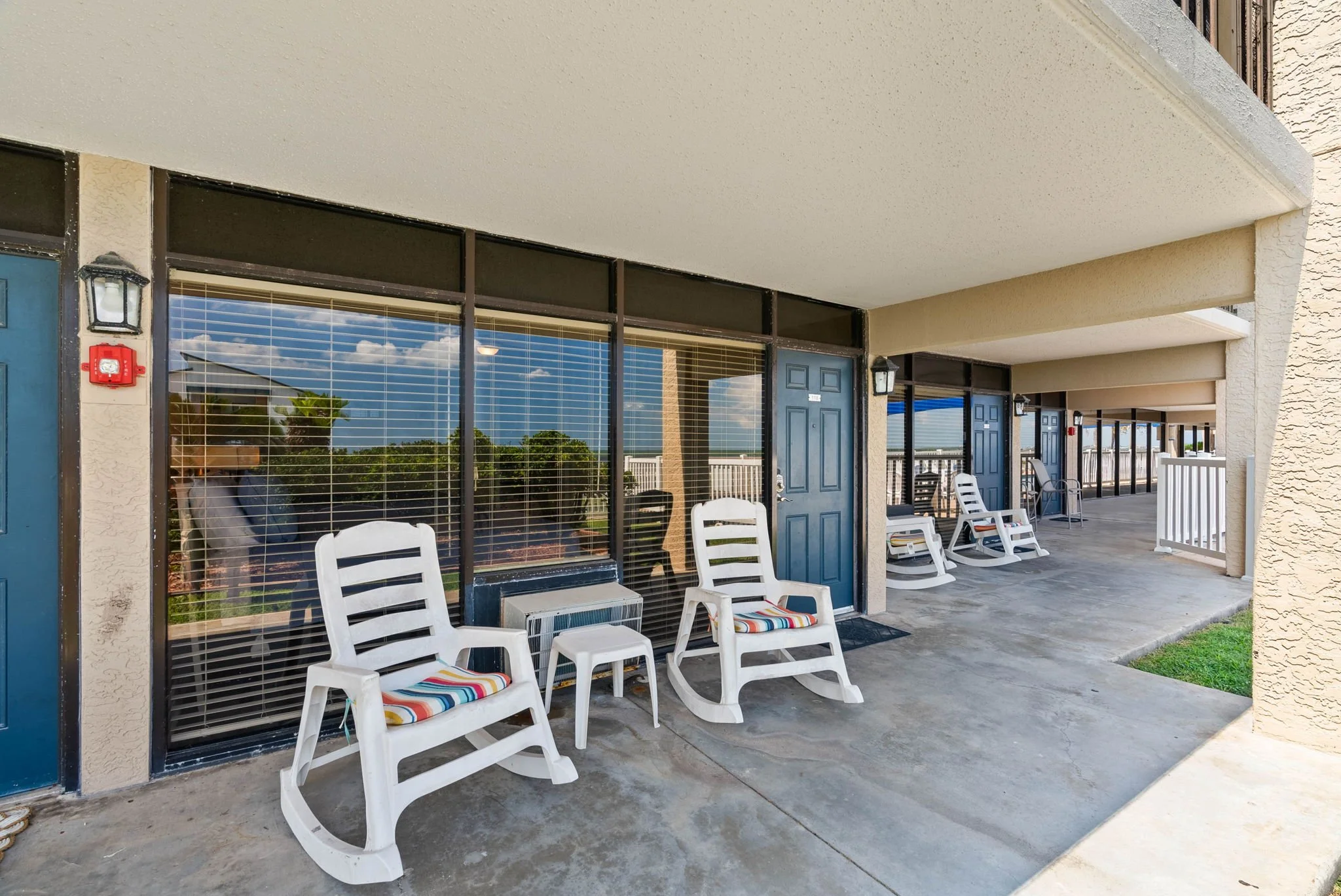 Private covered patio with rocking chairs at Rockport Retreat, relaxing Rockport TX coastal vacation rental