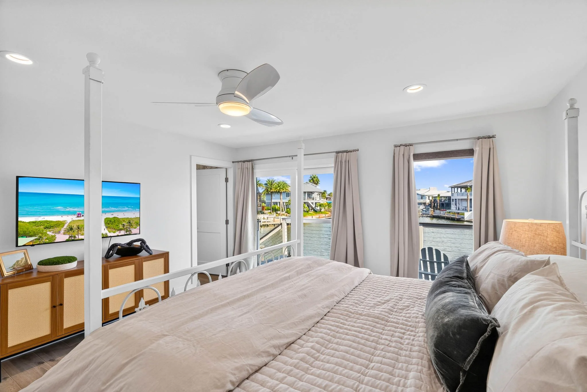 King bedroom overlooking the canal with private balcony in luxury Rockport TX waterfront vacation rental 