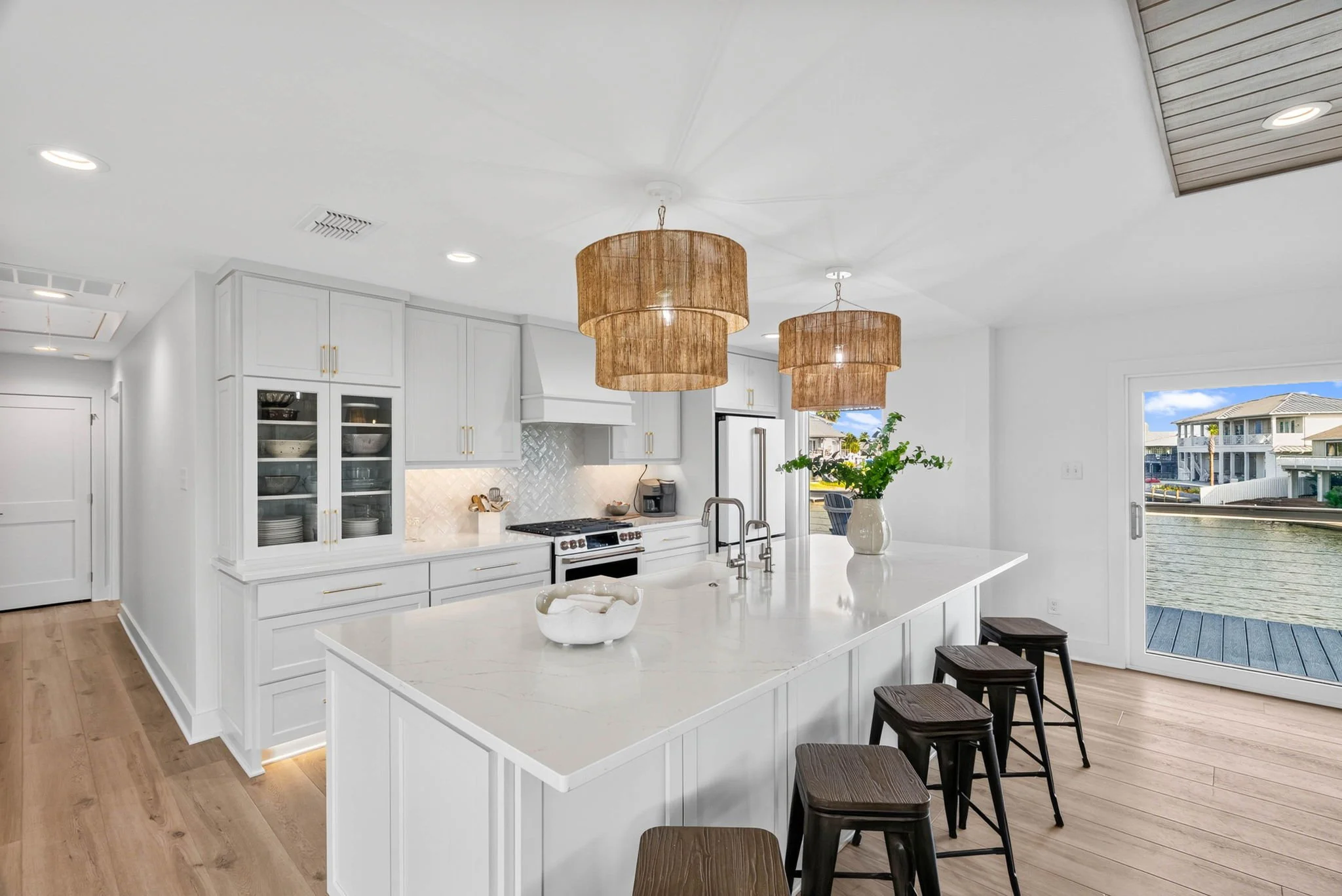 Bright coastal kitchen with oversized island and canal views at a luxury Rockport TX vacation rental.