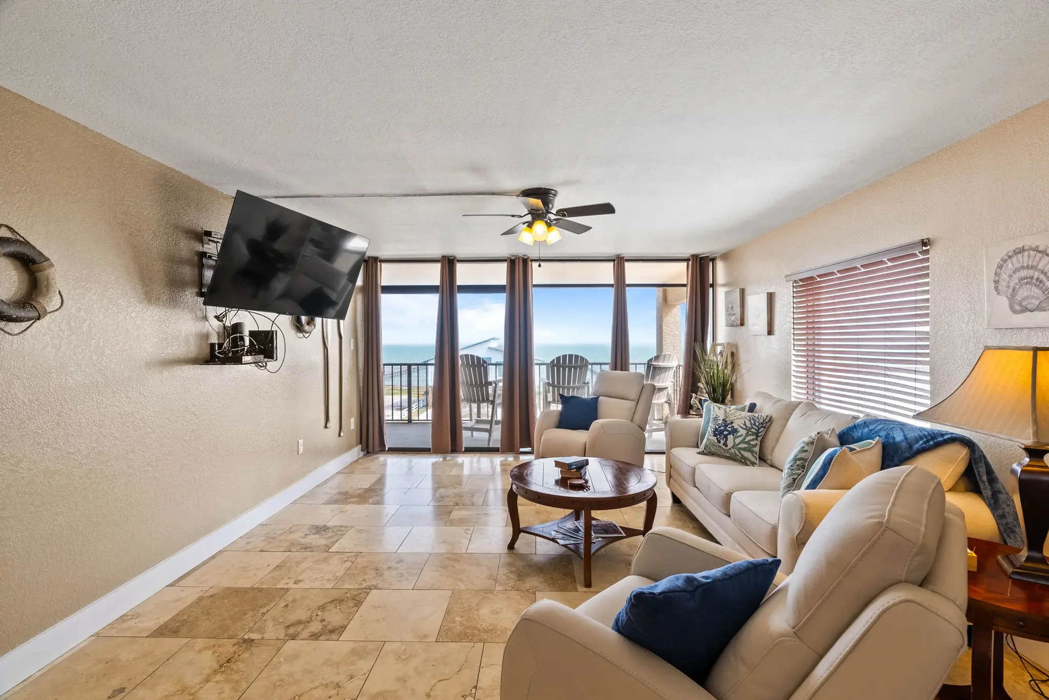 Living room with queen sleeper sofa and bay view windows – Grandview condo Rockport
