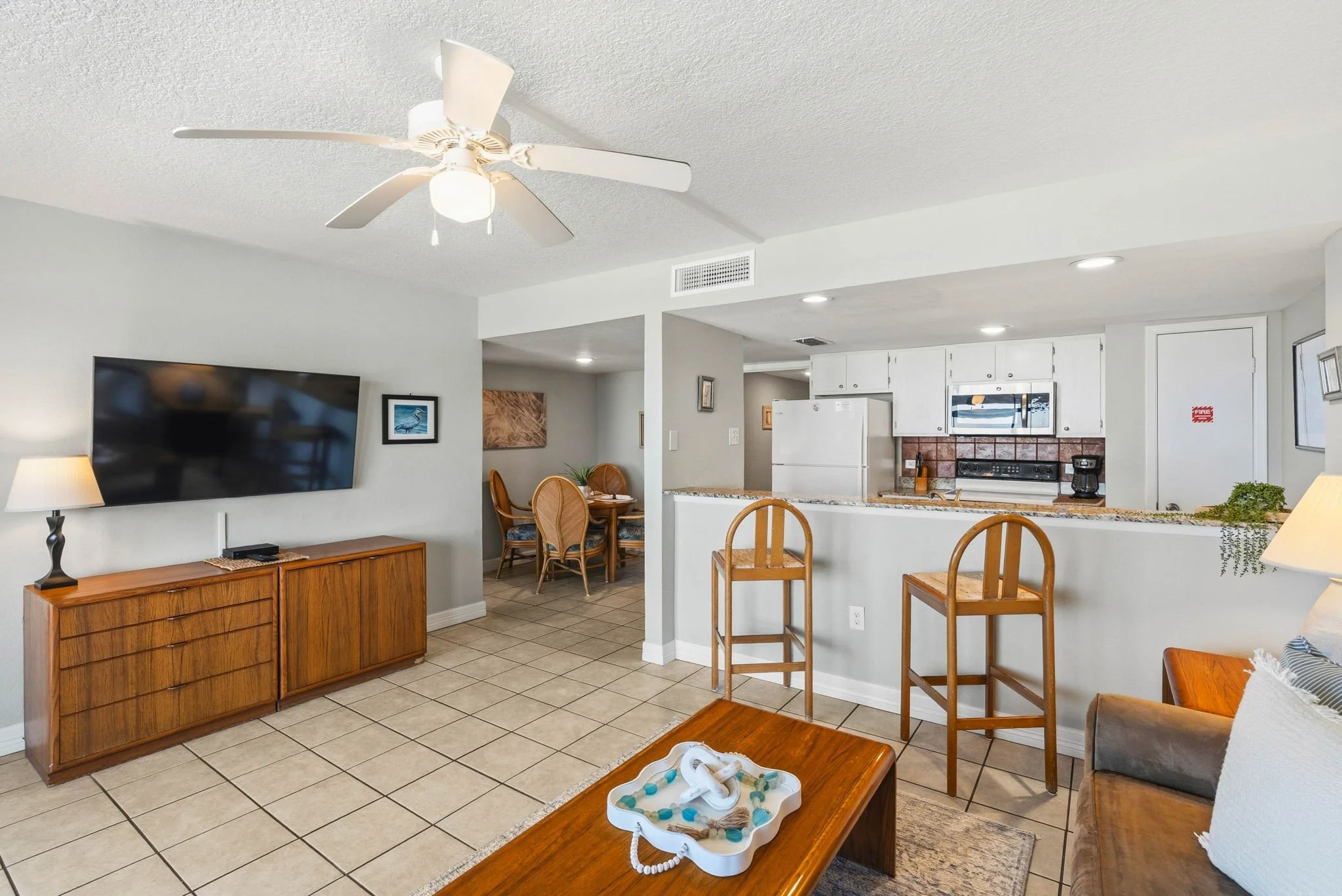 Spacious living and dining area with coastal charm at Peaceful Pelican Laguna Reef Unit 314