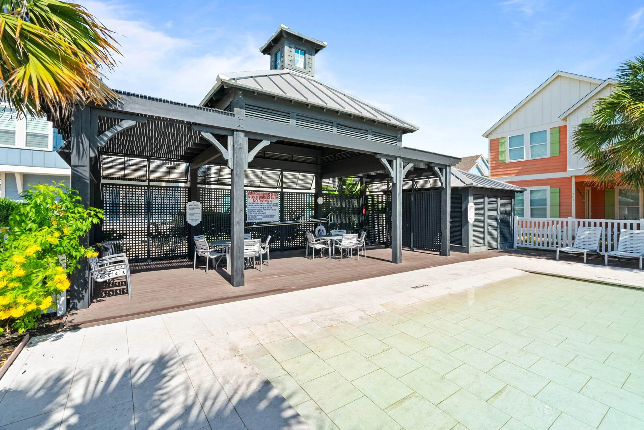 Covered outdoor dining space next to the pool at Marina Del Rey vacation rental community in Rockport Texas