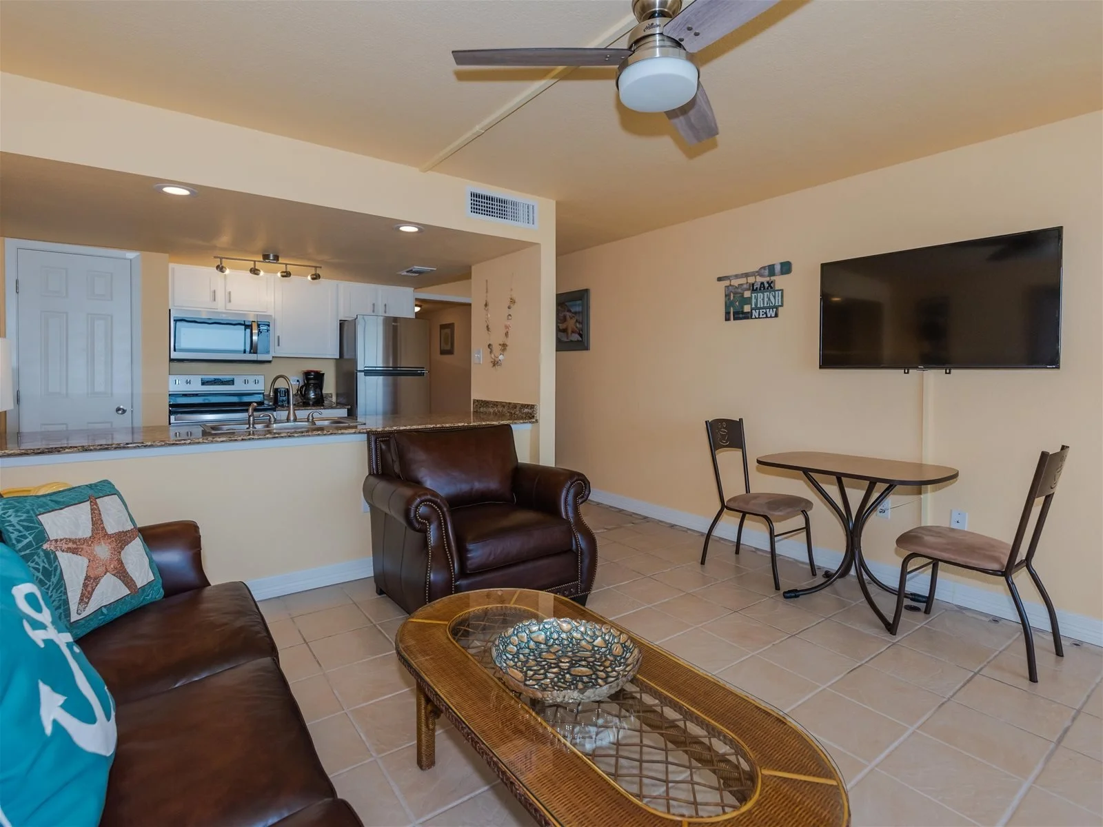 Living room with comfortable seating and balcony access – Paradise condo Rockport