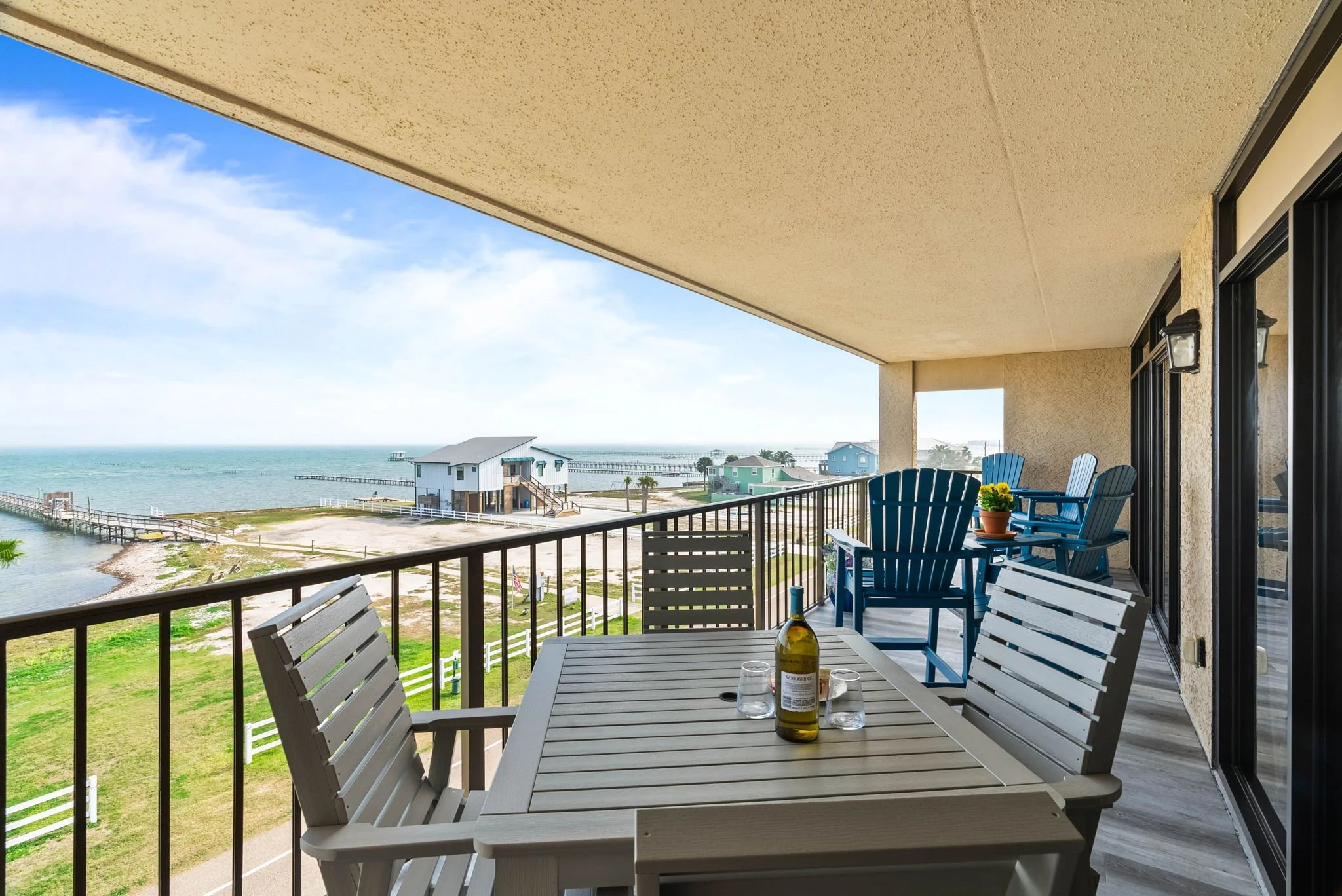 Waterfront balcony dining area overlooking fishing pier at Dayspring 402 Laguna Reef Rockport TX