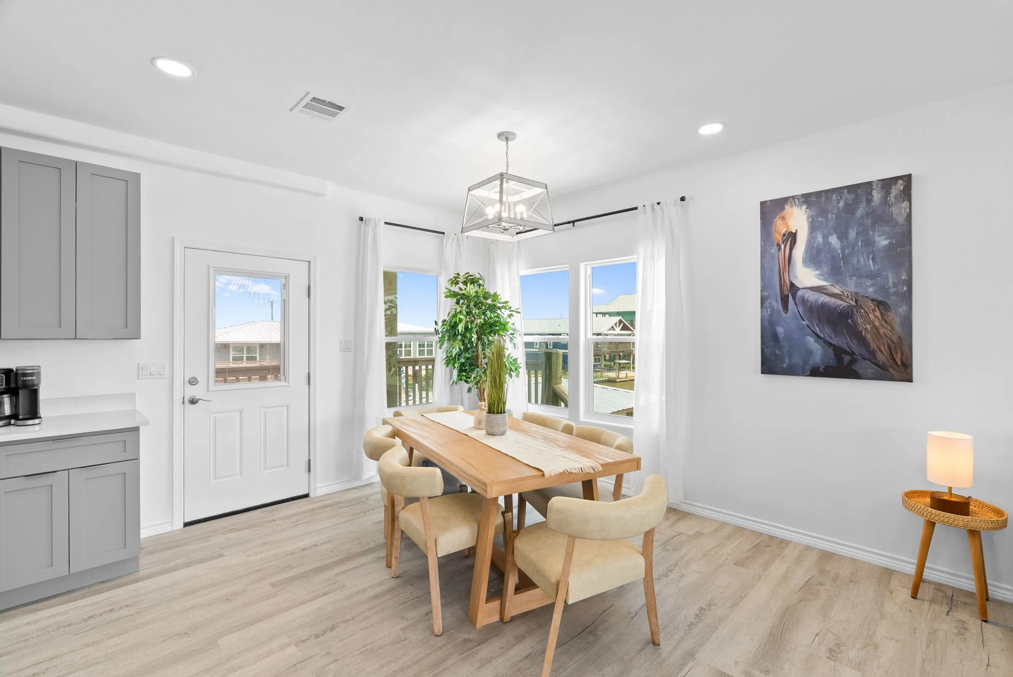 Open dining area with large table and natural light at Belaire Breeze coastal home