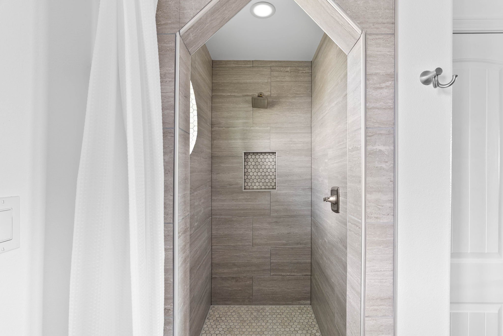 Elegant powder room with marble vanity and designer finishes in a luxury coastal home in Rockport TX.