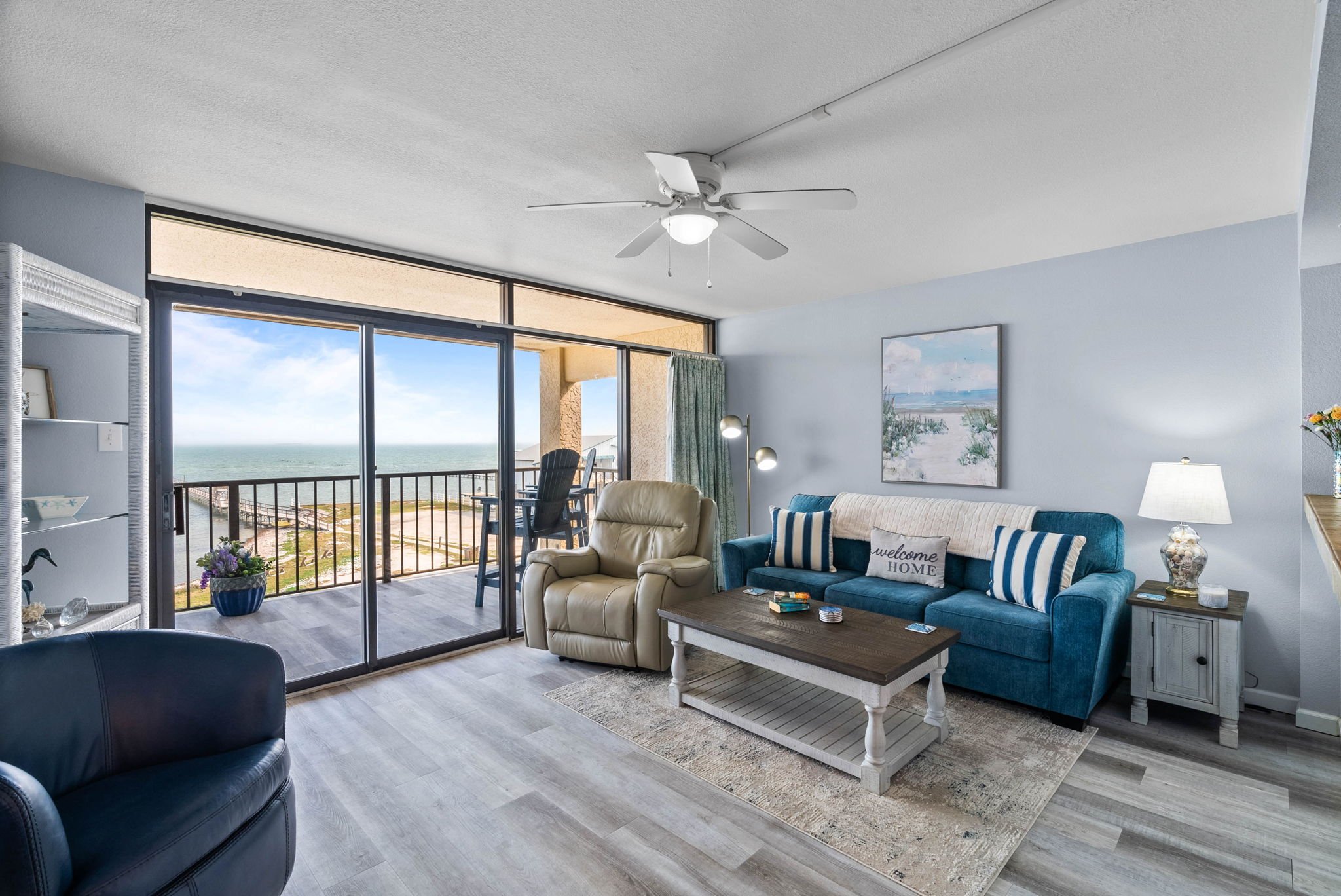 Waterfront living room with balcony and bay views at Dayspring Unit 402 Laguna Reef Rockport TX
