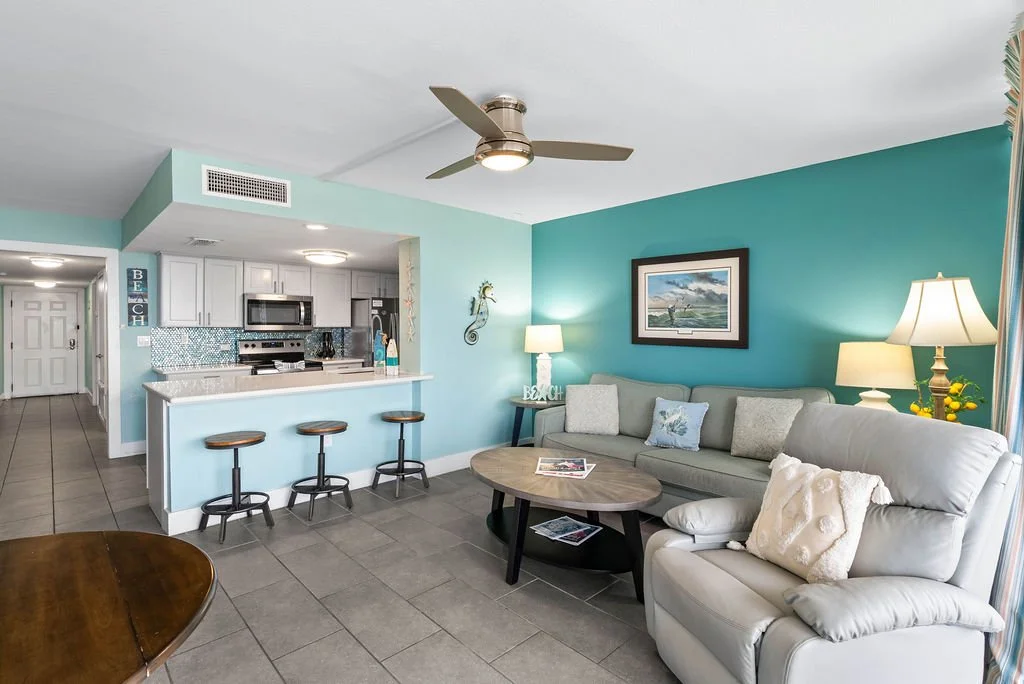 Bright and breezy living room with ocean tones and stylish furnishings in Laguna Reef Unit 310, Rockport TX.