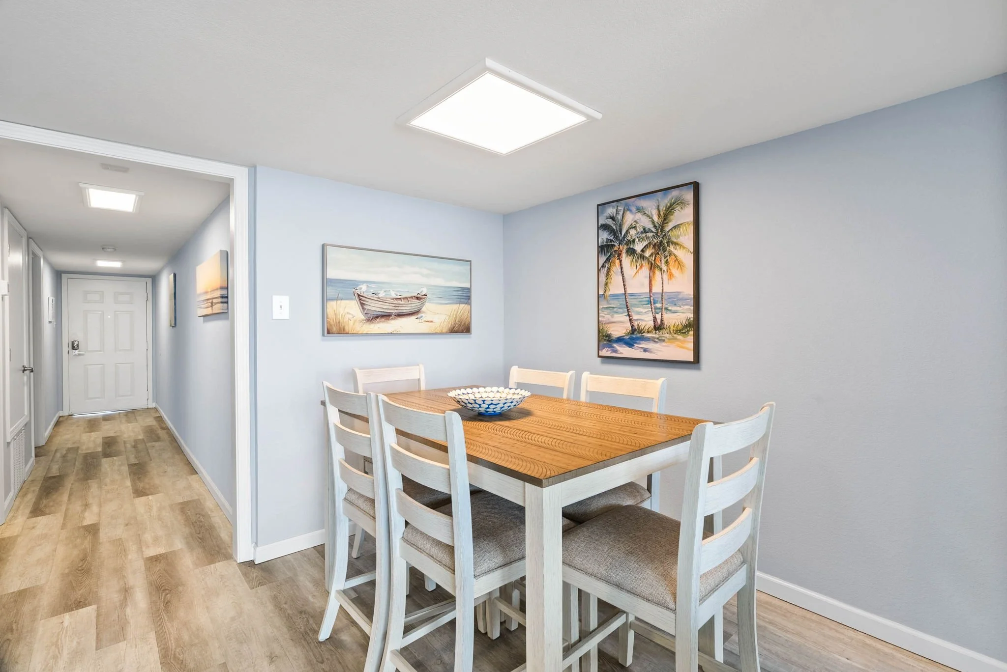 Dining area with coastal artwork inside Dayspring 402 at Laguna Reef Rockport TX vacation condo