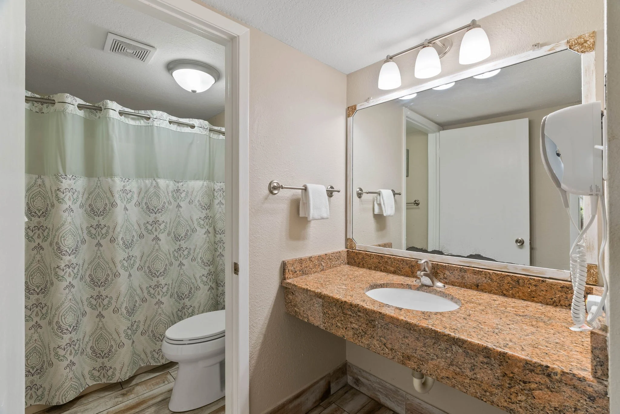 Full bathroom with granite vanity and tub shower at Rockport Retreat, Laguna Reef Condos Rockport TX