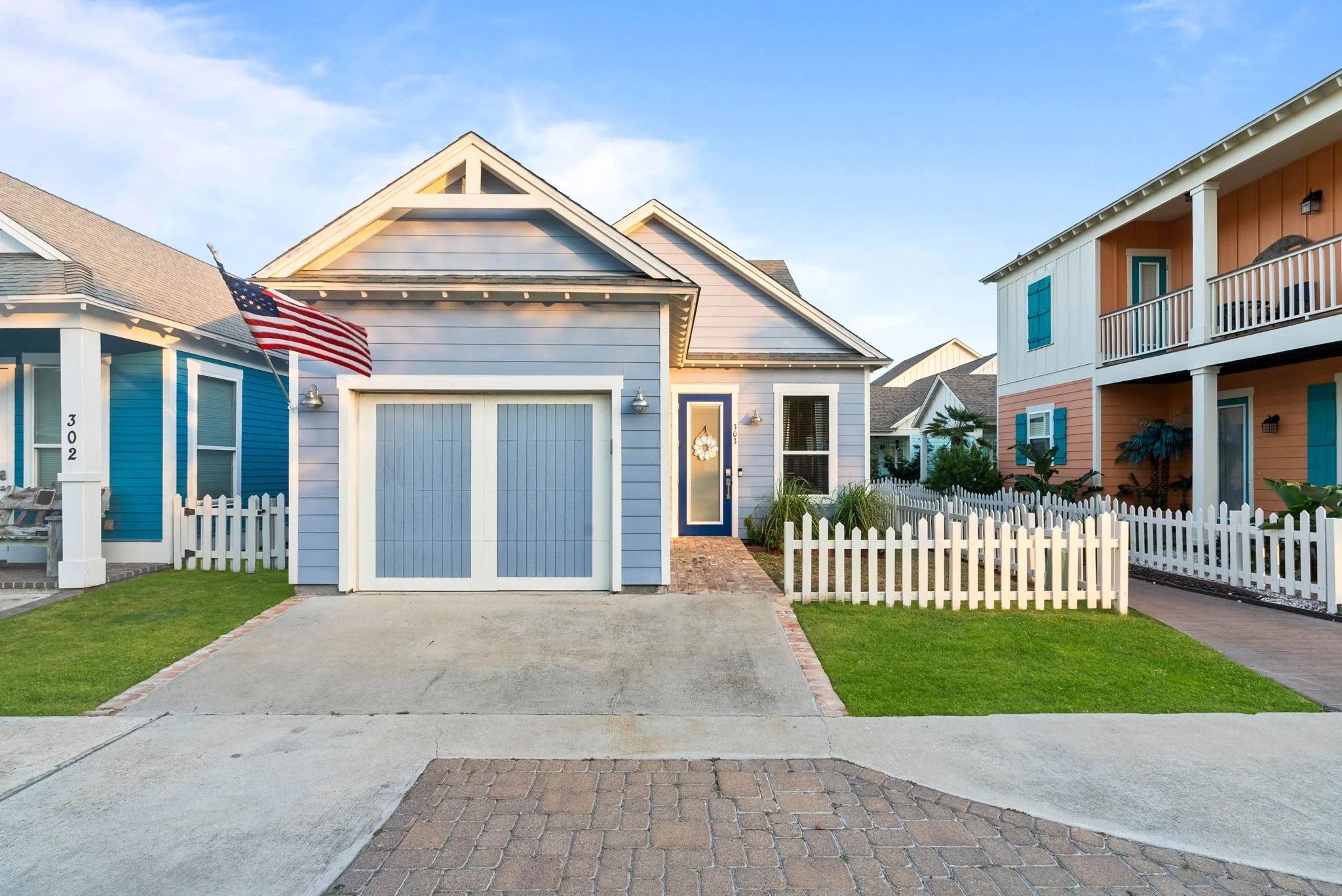 Front view of Marina Del Rey vacation rental in Rockport TX with American flag and coastal cottage charm