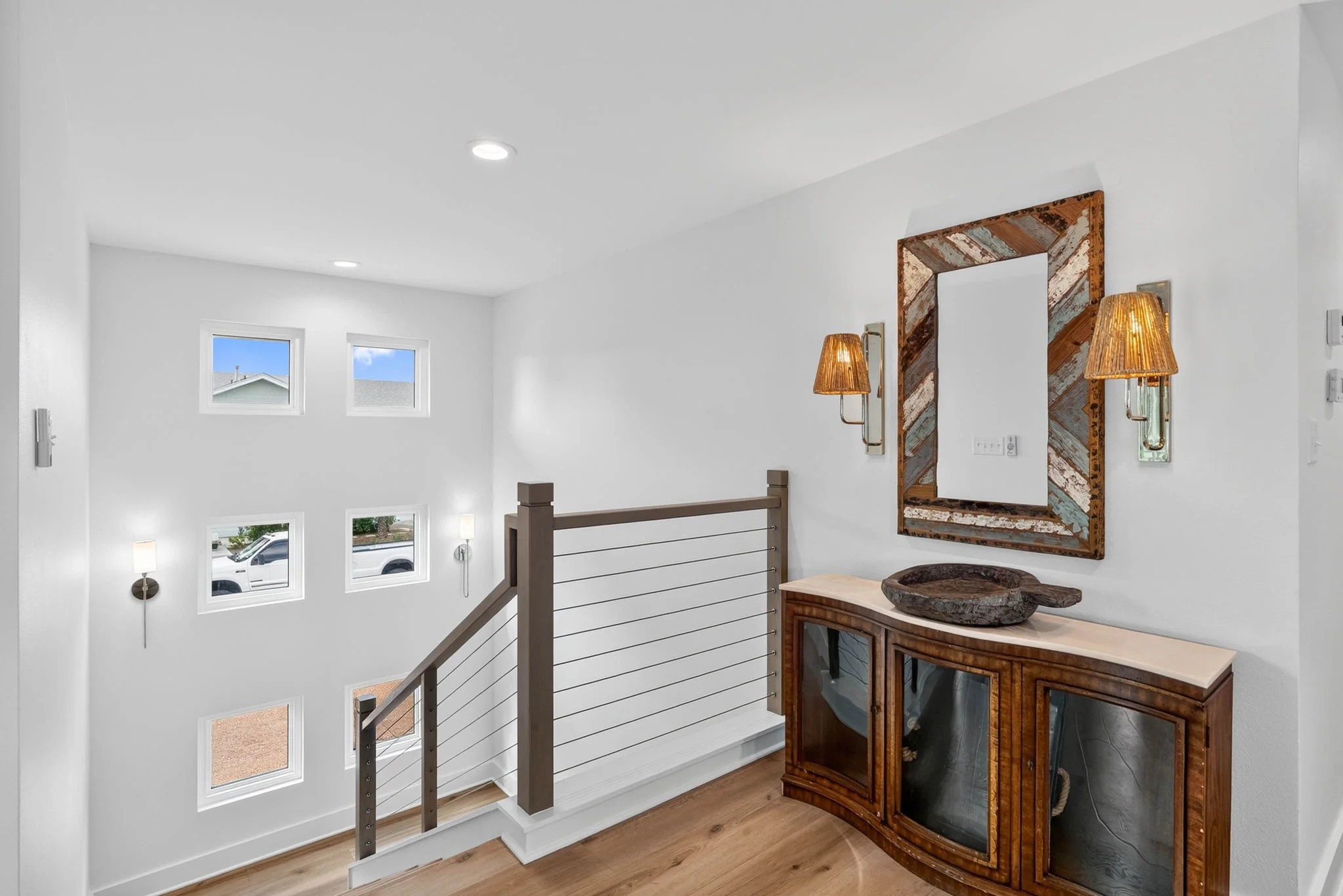 Coastal staircase landing with modern finishes inside a luxury Rockport TX vacation rental. 