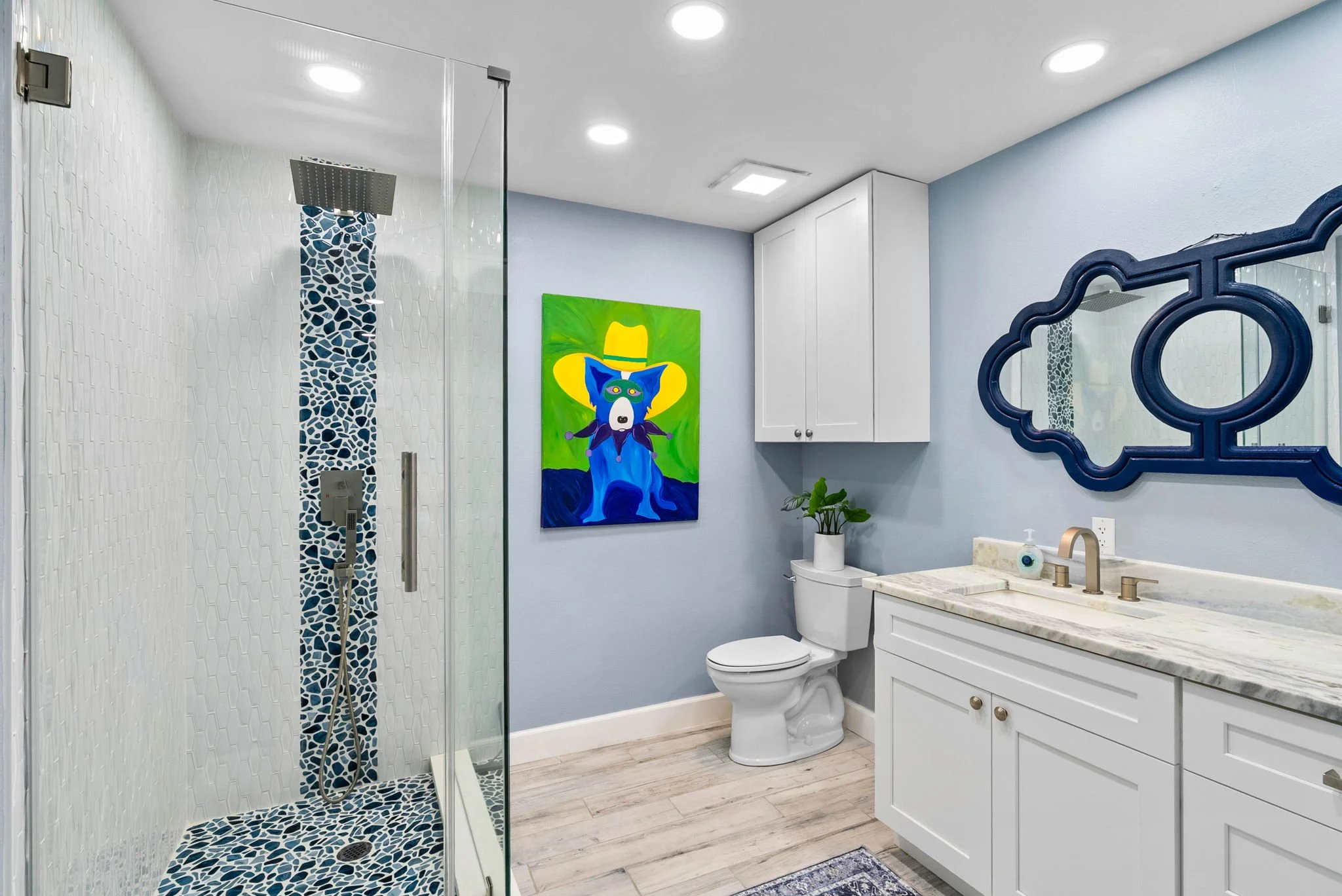 Spa-style bathroom with glass walk-in shower and custom blue tile accents in a luxury Rockport TX vacation rental.