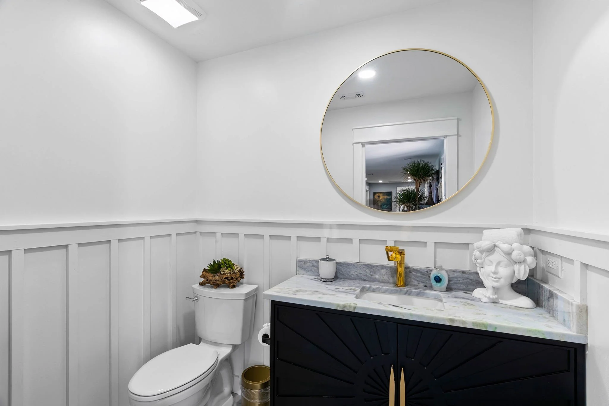 Elegant powder room with marble vanity and designer finishes in a luxury coastal home in Rockport TX.
