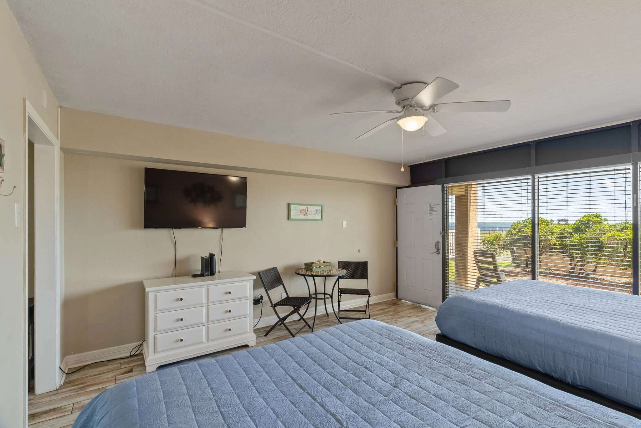 Spacious bedroom with TV and seating at Rockport Retreat, comfortable Rockport TX vacation rental