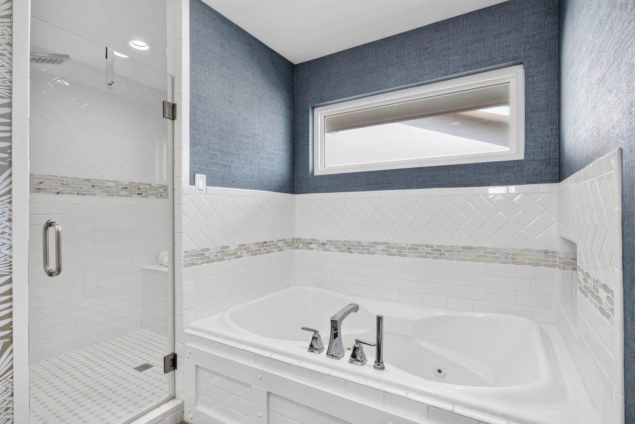 Spa-style jetted tub and glass walk-in shower in luxury Rockport TX waterfront vacation rental 