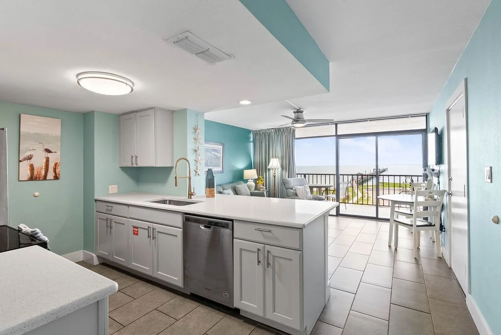 Coastal kitchen with ocean views and quartz countertops at Beauty Blues condo in Laguna Reef Rockport.