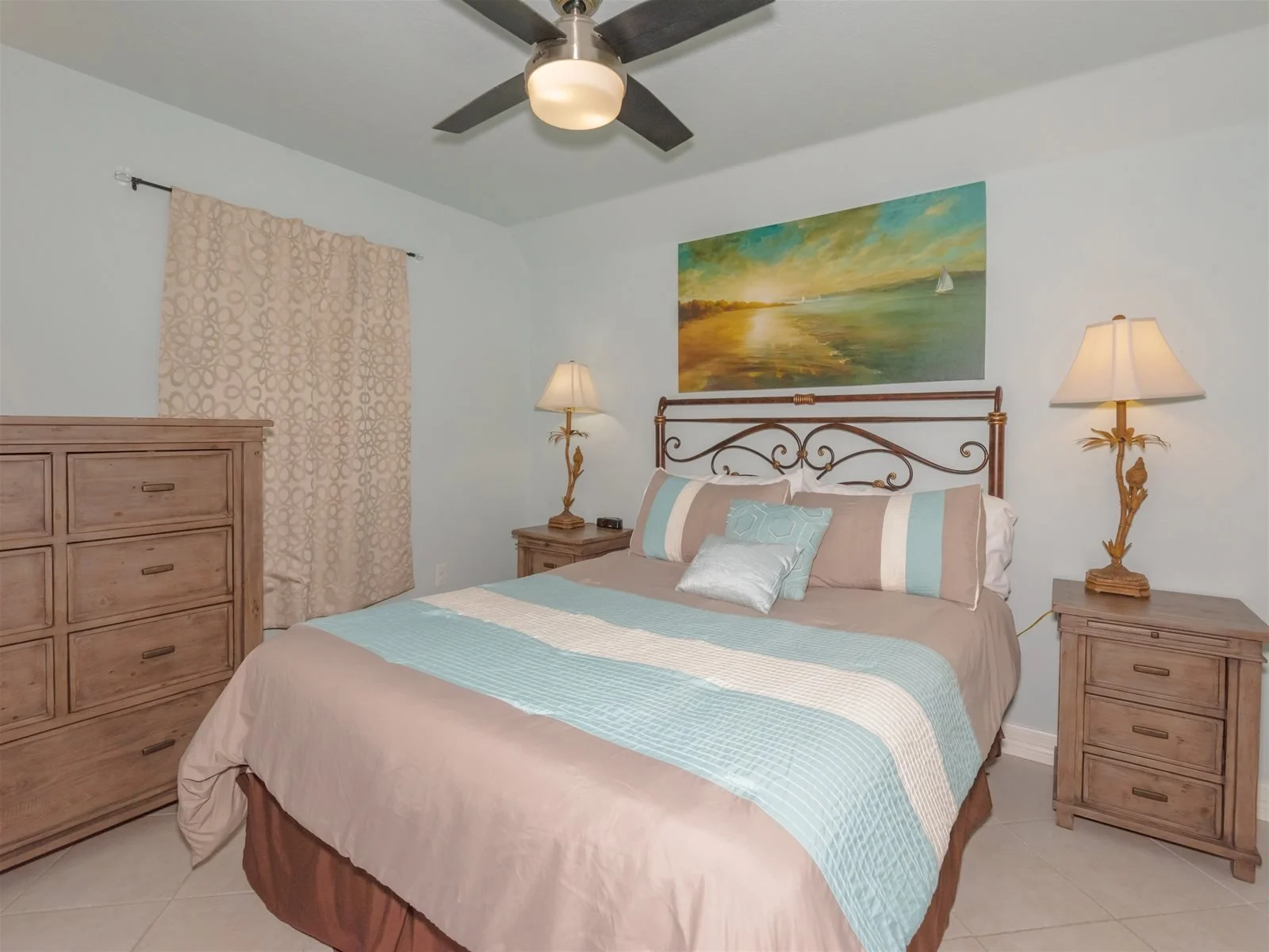 King bedroom with flat-screen TV and coastal décor – Laguna Reef Rockport
