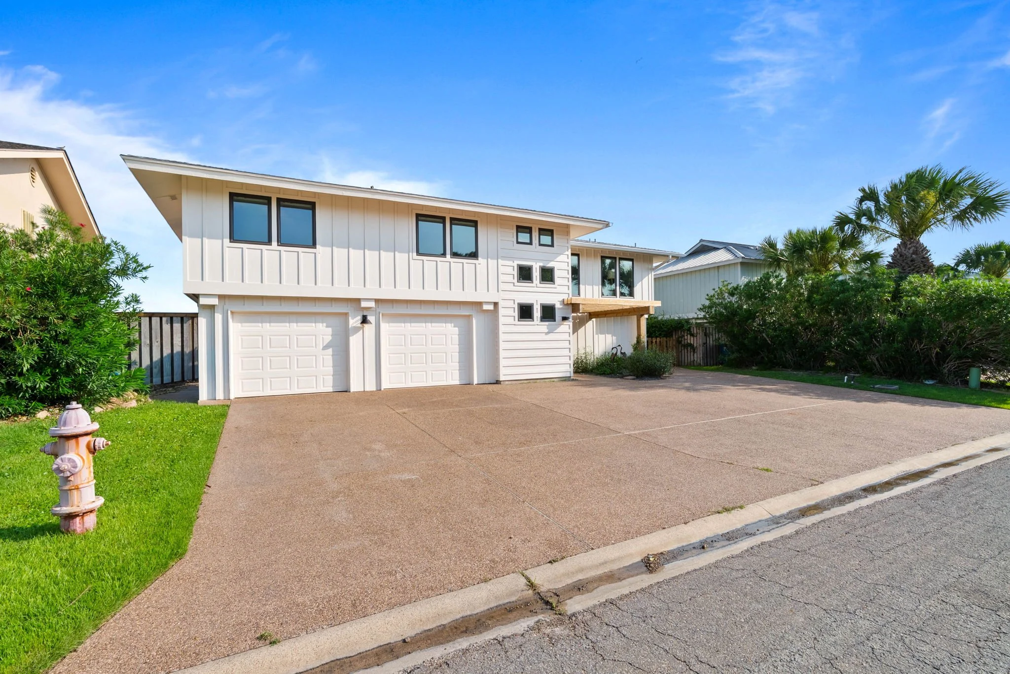 Modern exterior of George's Landing with spacious driveway in Rockport TX waterfront vacation rental 
