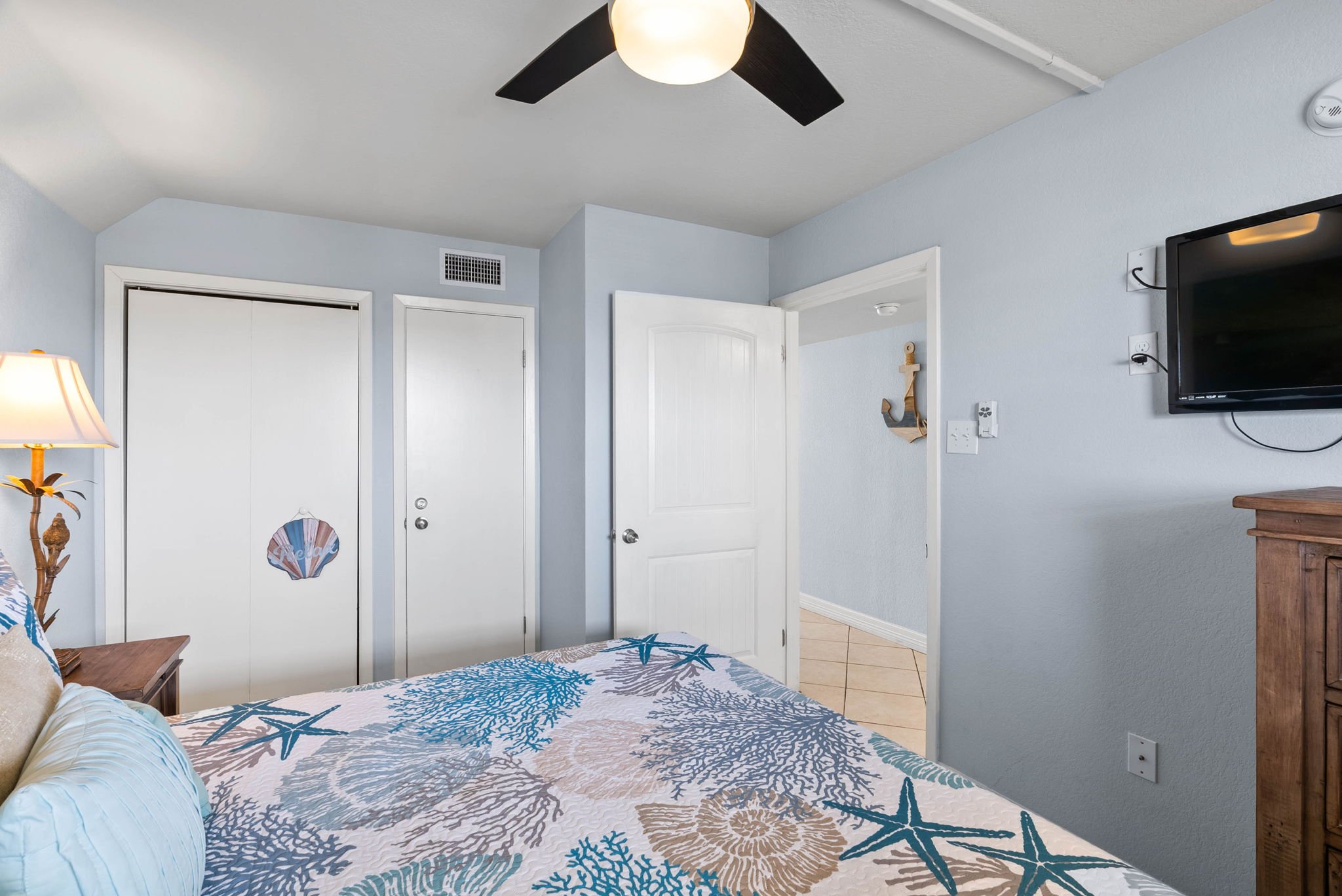 Spacious coastal bedroom with king bed and TV in Tradewinds 305 at Laguna Reef condos in Rockport TX