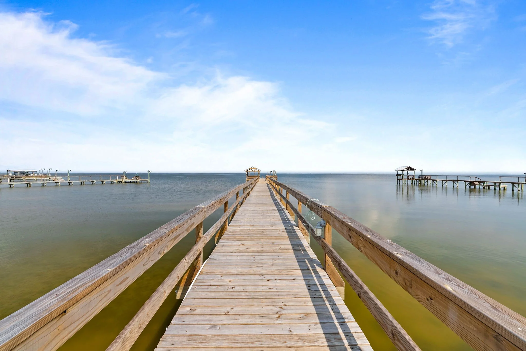 Long private fishing pier with panoramic bay views at a luxury Rockport TX waterfront retreat.