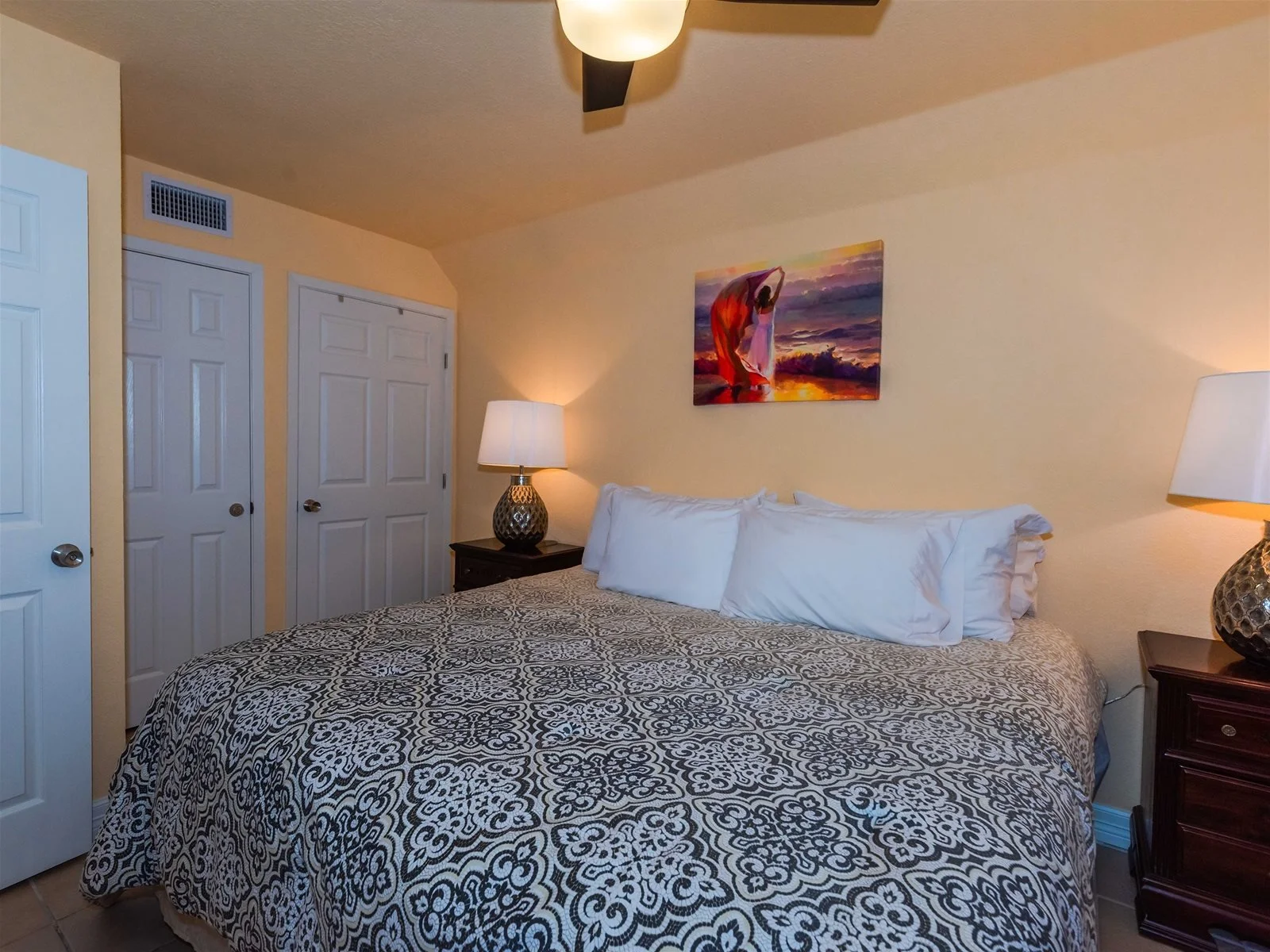 King bedroom with flat-screen TV and coastal décor – Laguna Reef Rockport