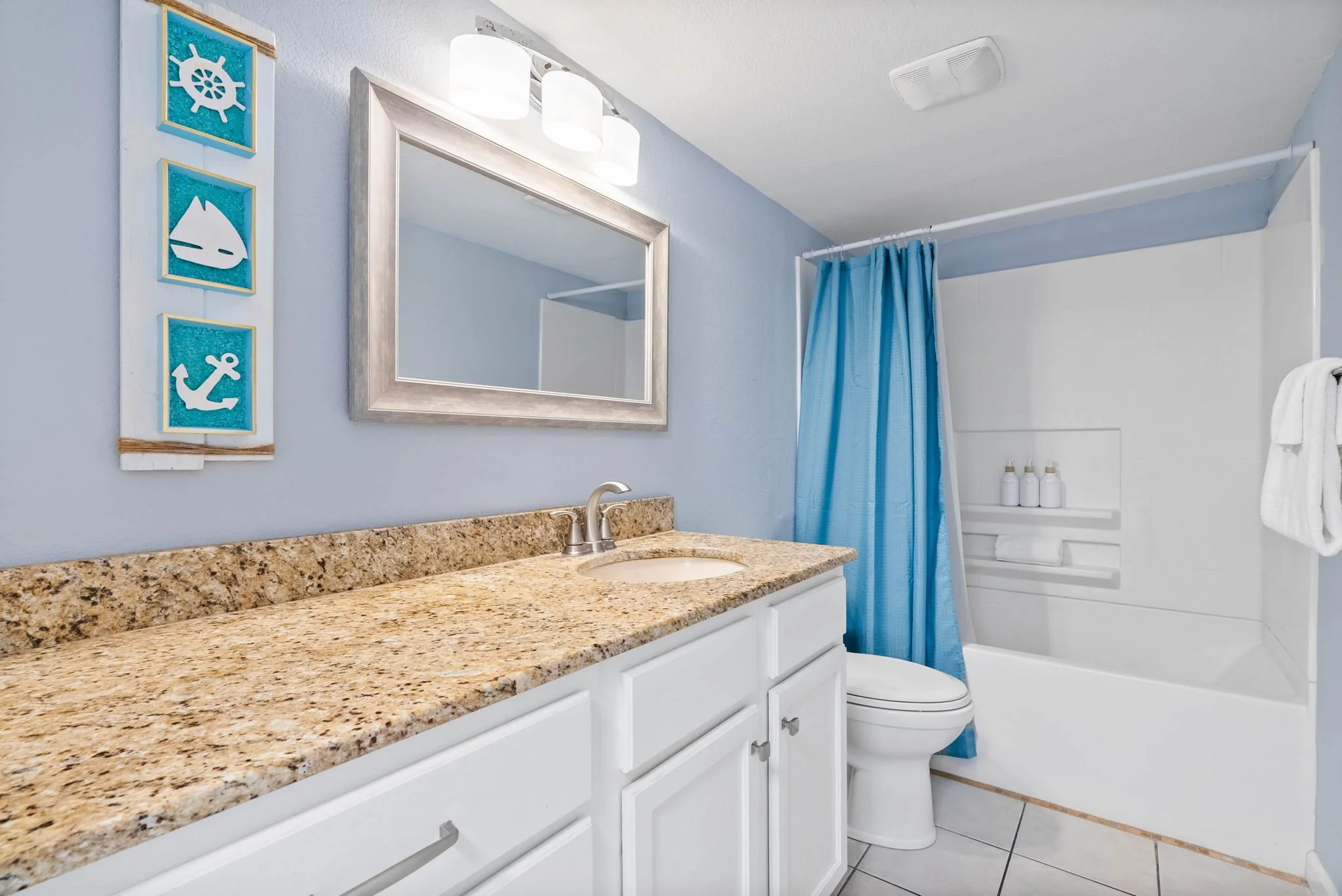 Coastal bathroom with granite vanity and tub shower at Dayspring 402, Laguna Reef Rockport TX vacation rental