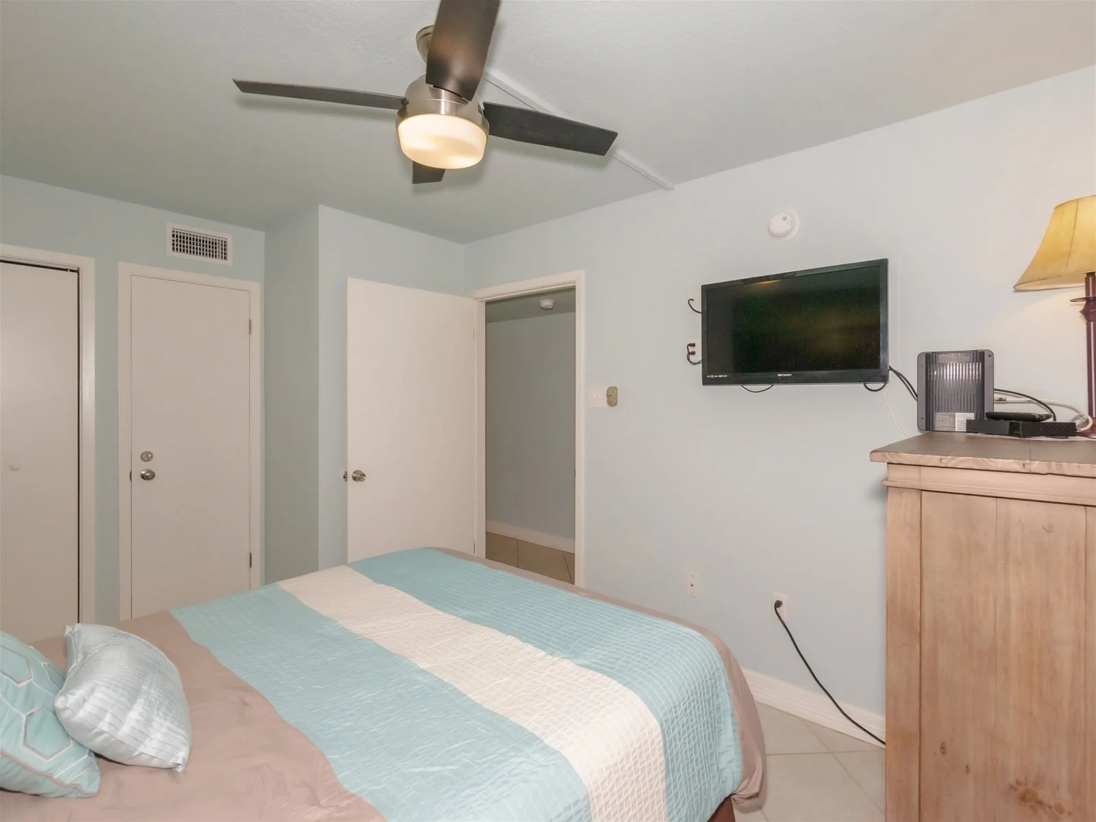 King bedroom with flat-screen TV and coastal décor – Laguna Reef Rockport