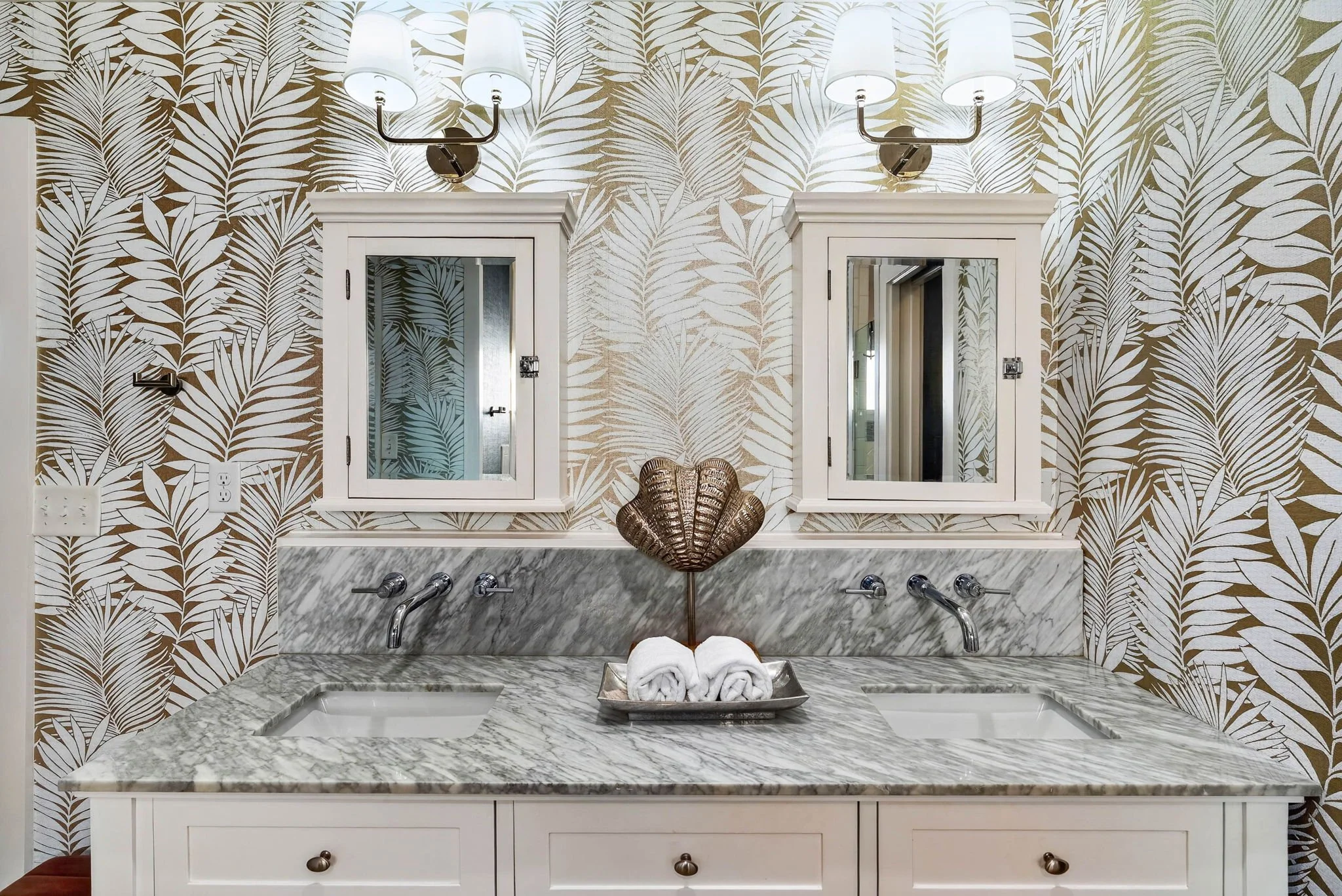 Double vanity with marble countertops and designer palm wallpaper in George's Landing waterfront vacation rental 