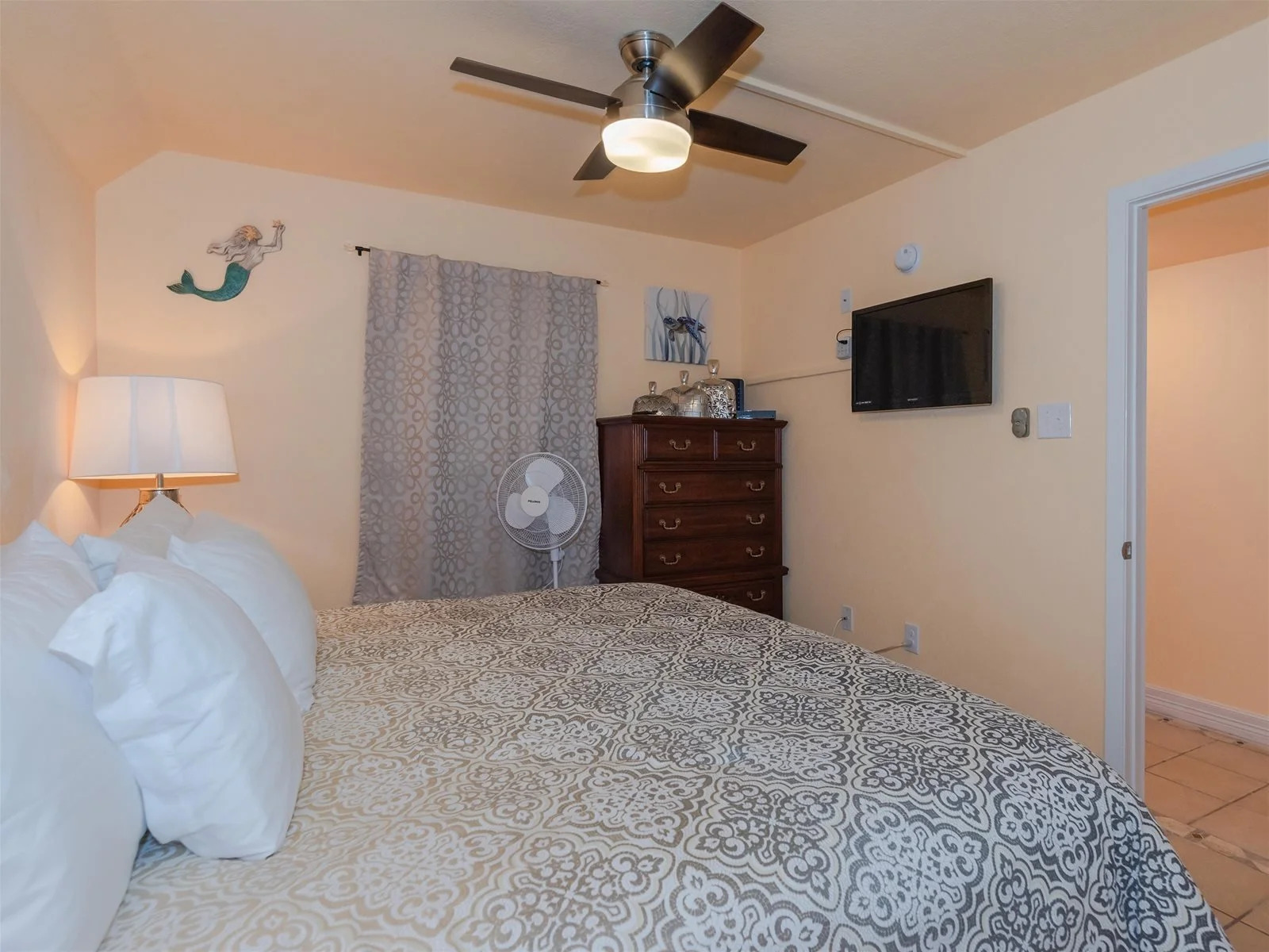 King bedroom with flat-screen TV and coastal décor – Laguna Reef Rockport