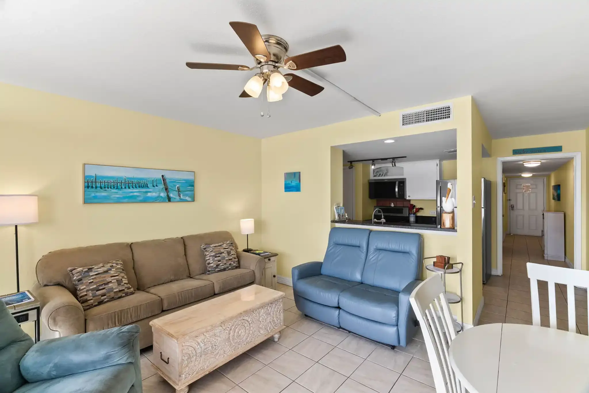 Inviting open living area with coastal décor, comfortable seating and an adjoining kitchen in this Rockport, TX vacation rental.