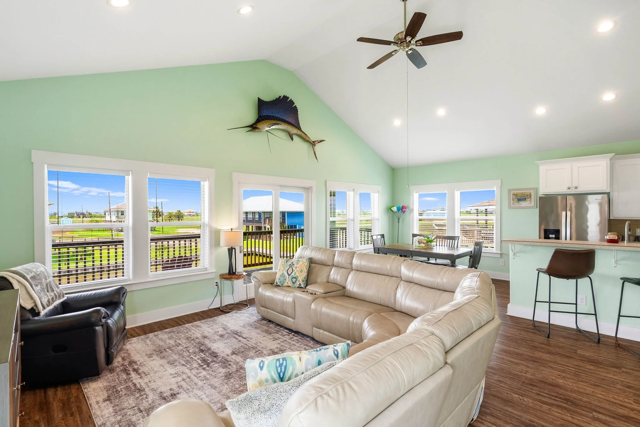 Bright open living room with vaulted ceilings and balcony access at a luxury Rockport TX vacation rental.