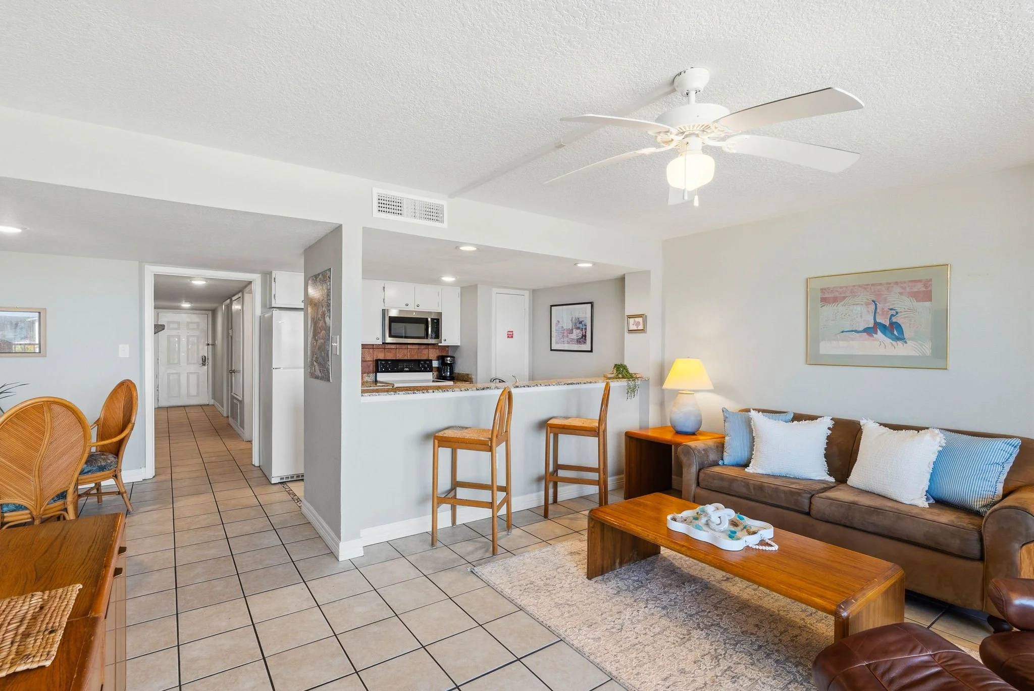 Coastal living room with breakfast bar and waterfront balcony at luxury Rockport TX stay