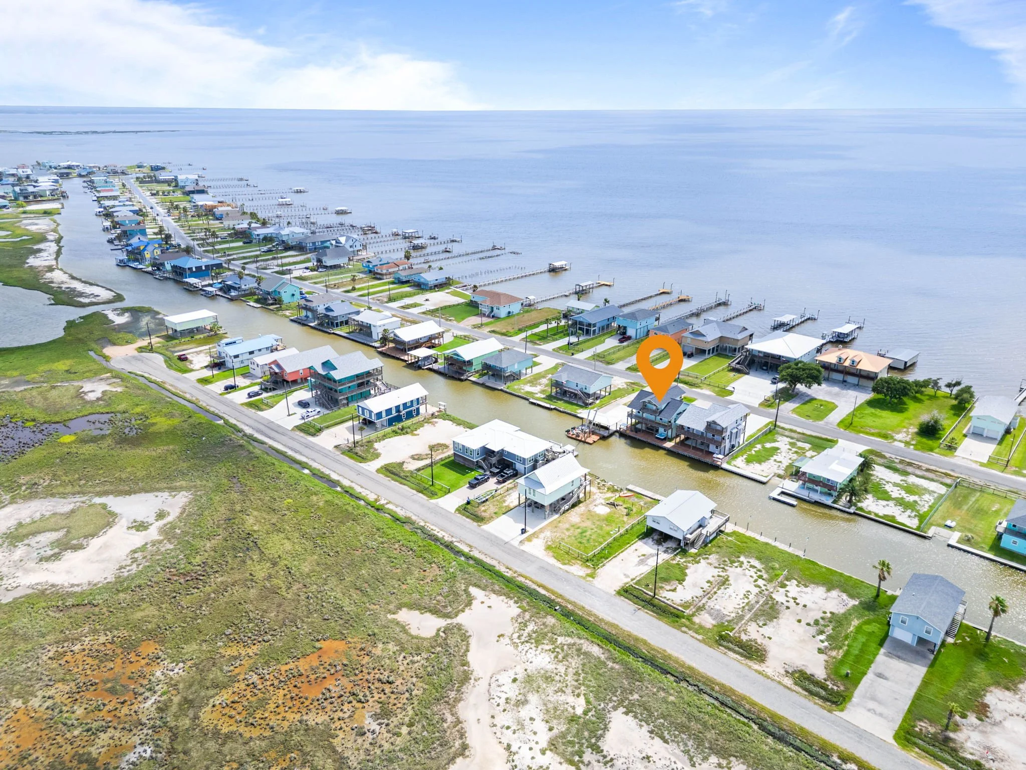 Wide aerial locating the canal-front Rockport TX vacation rental near the bay