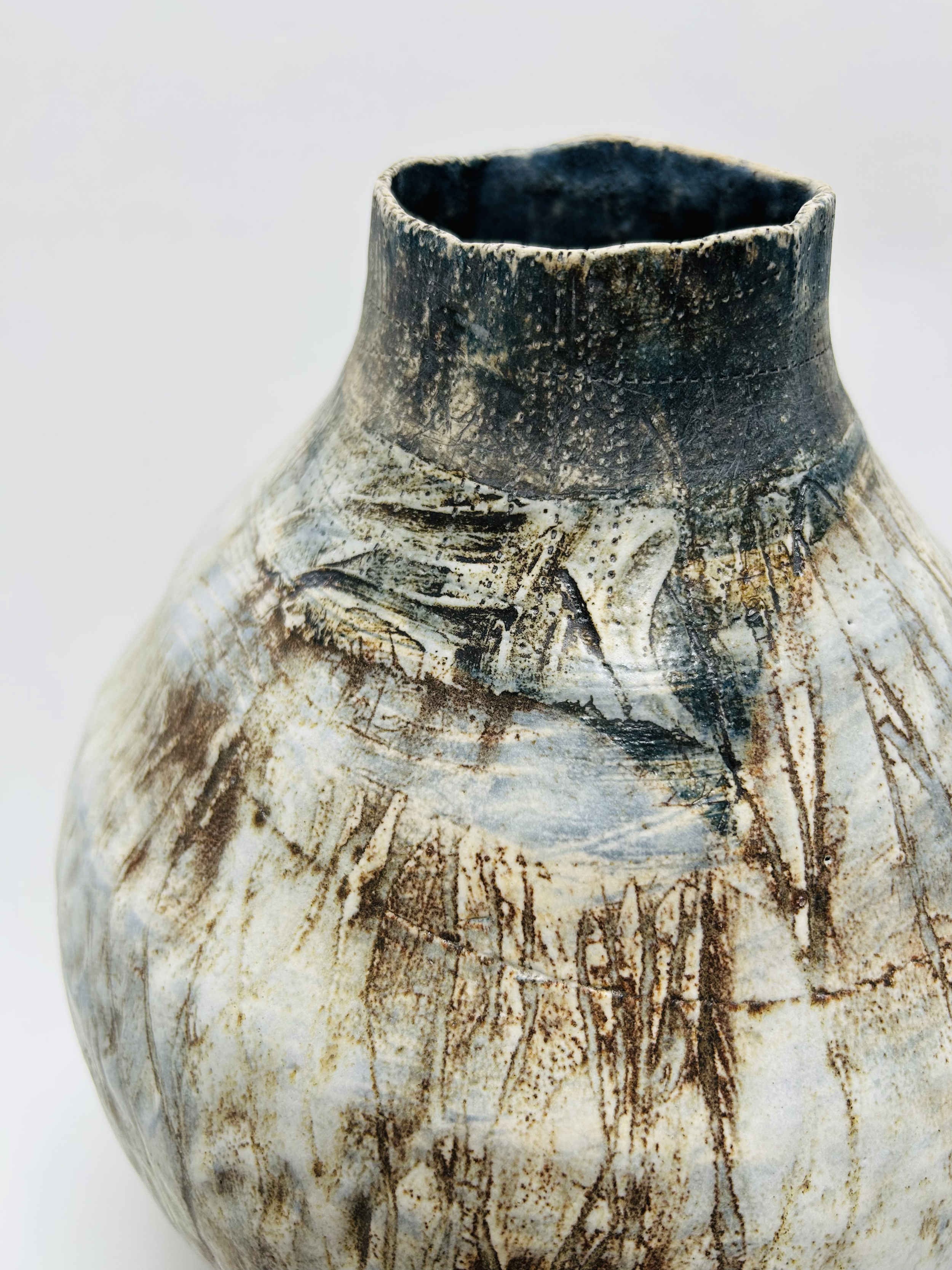  Toby  
Hand built coil vessel using white stoneware clay. Decorated with layers of underglaze, oxides and finished with a poured white glaze.
