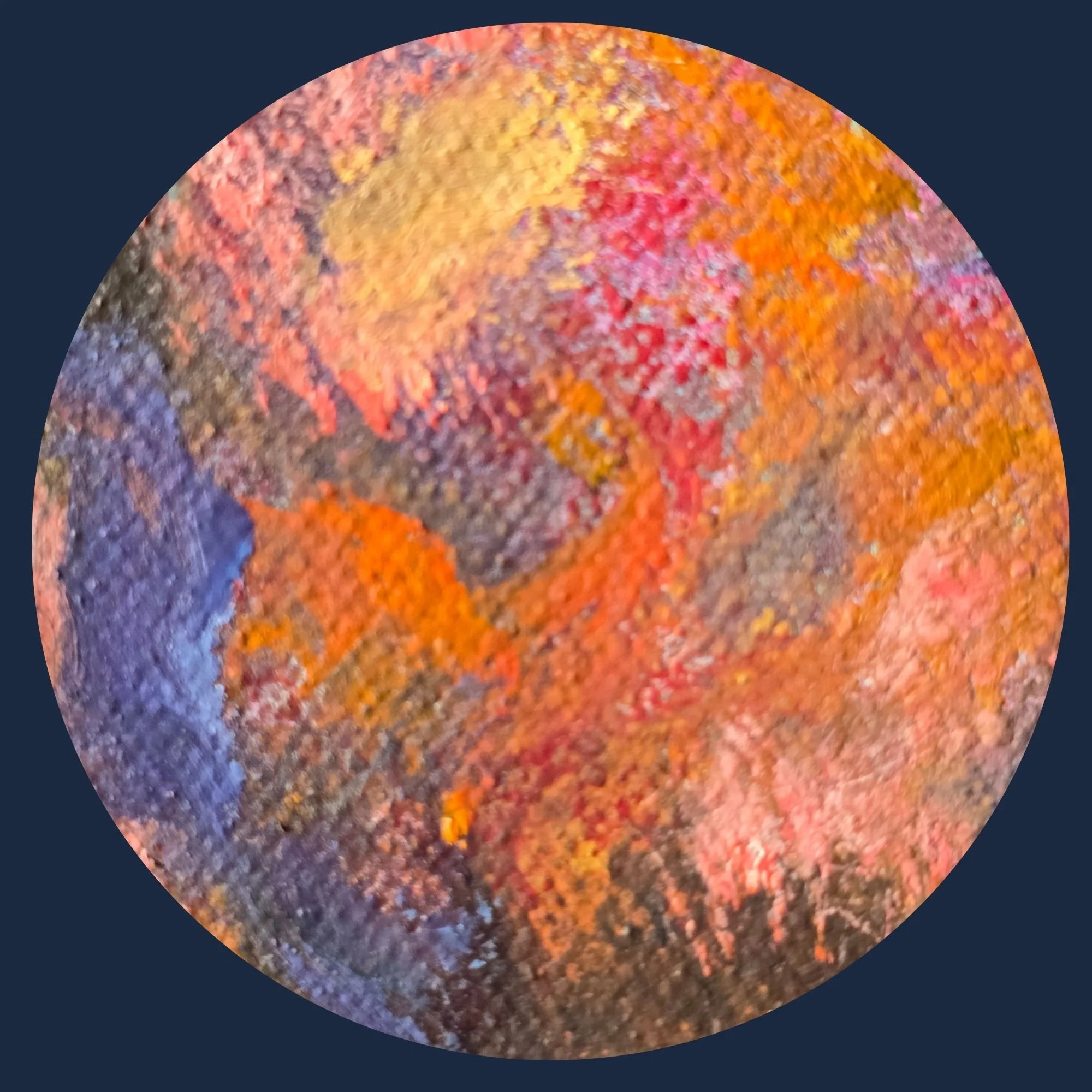 Close-up of a colorful, textured autumn leaf showing shades of orange, red, yellow, and purple.