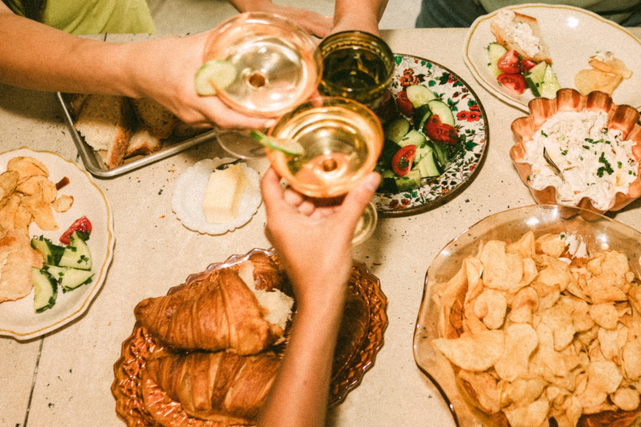 trio toast with wine  over plates of food at event