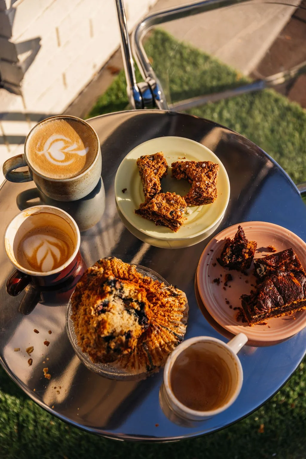 food and pastries laid out on a mirrored table 