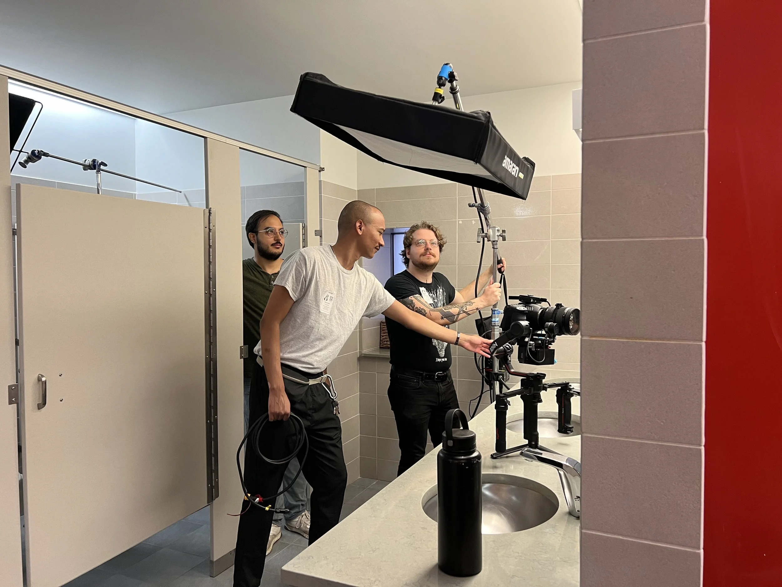  DP Chris Tremblay, gaffer Chris Inman, and grip Marcus Brown setup lights in the Trevor bathroom 