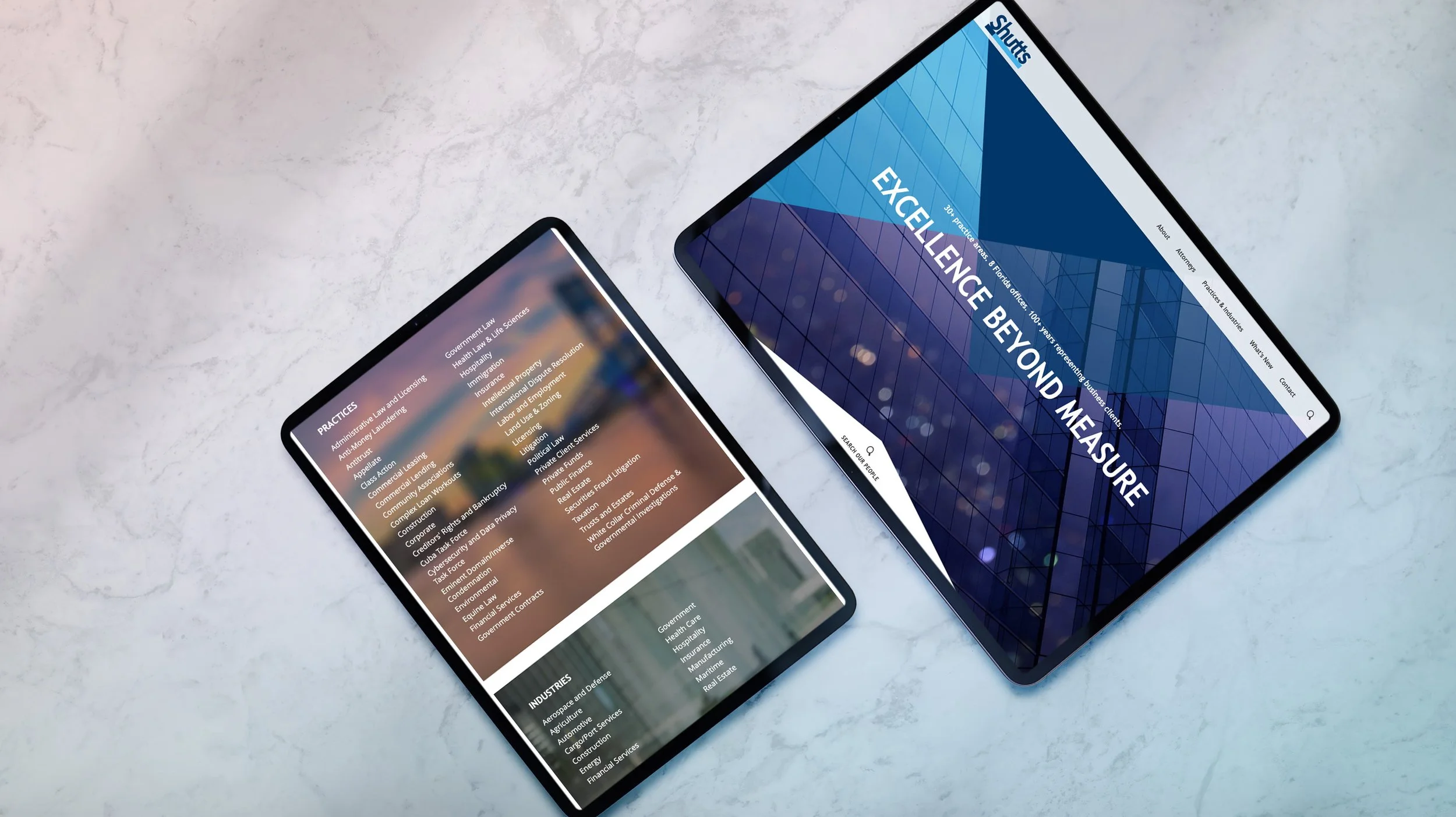 Two tablets displaying Shutts law firm website pages, including a homepage hero and practices and industries section, on a light surface.