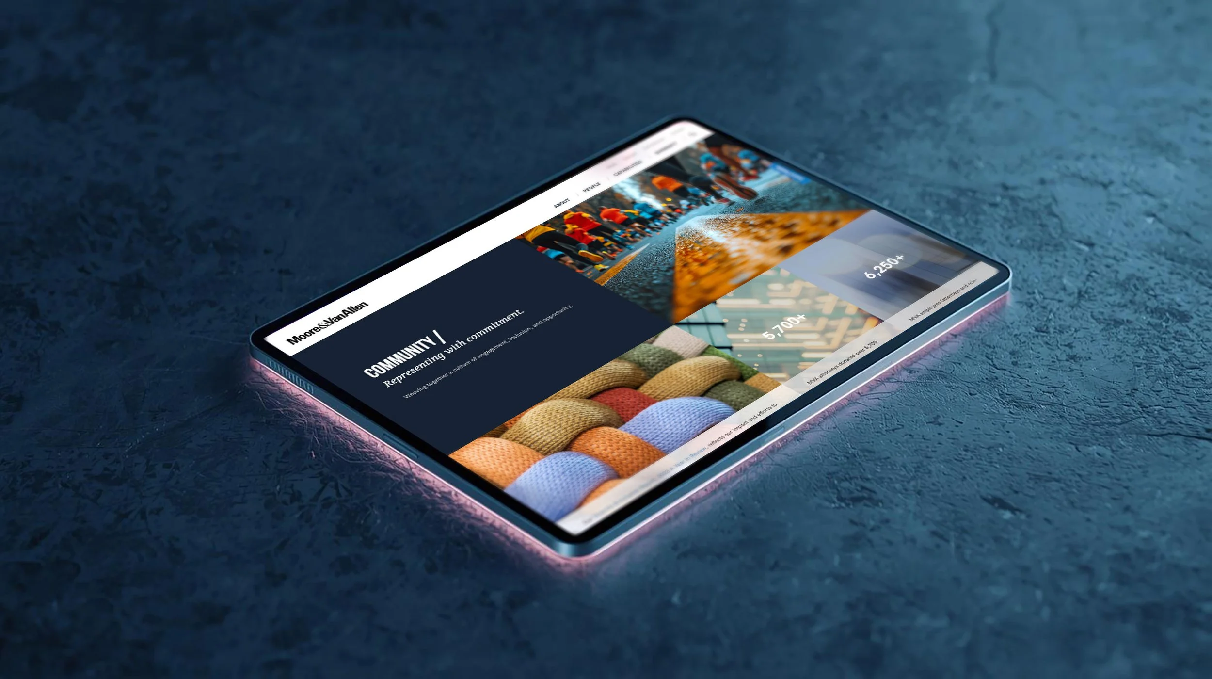 Tablet displaying Moore & Van Allen law firm website homepage with a bold, image-driven layout on a dark surface.