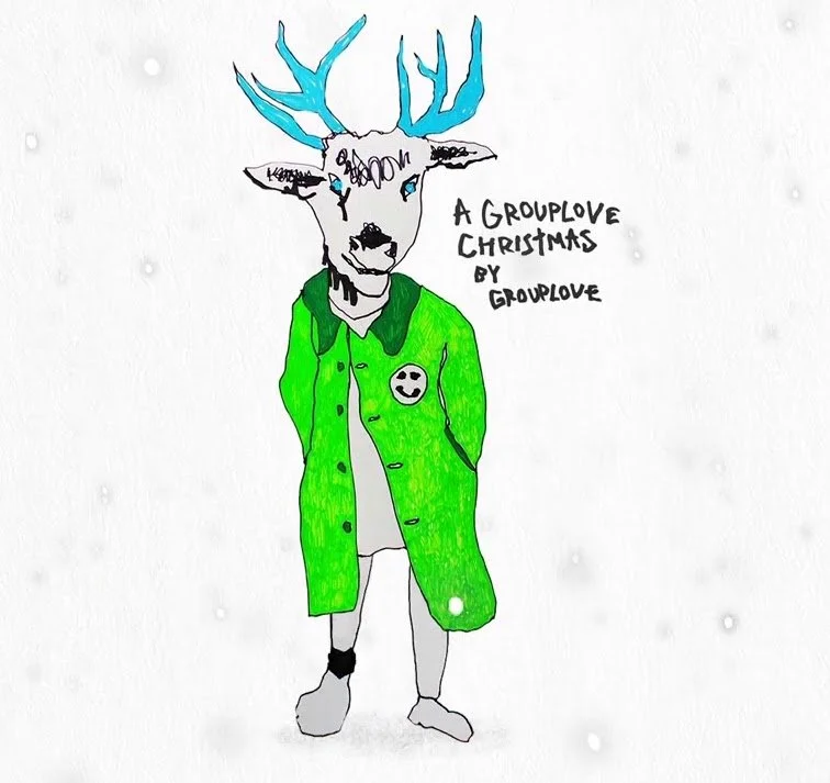 A drawing of a deer with blue antlers and blue eyes, wearing a bright green coat with a smiley face button, standing on two legs, with the text 'A Grouplove Christmas by Grouplove' written beside it.