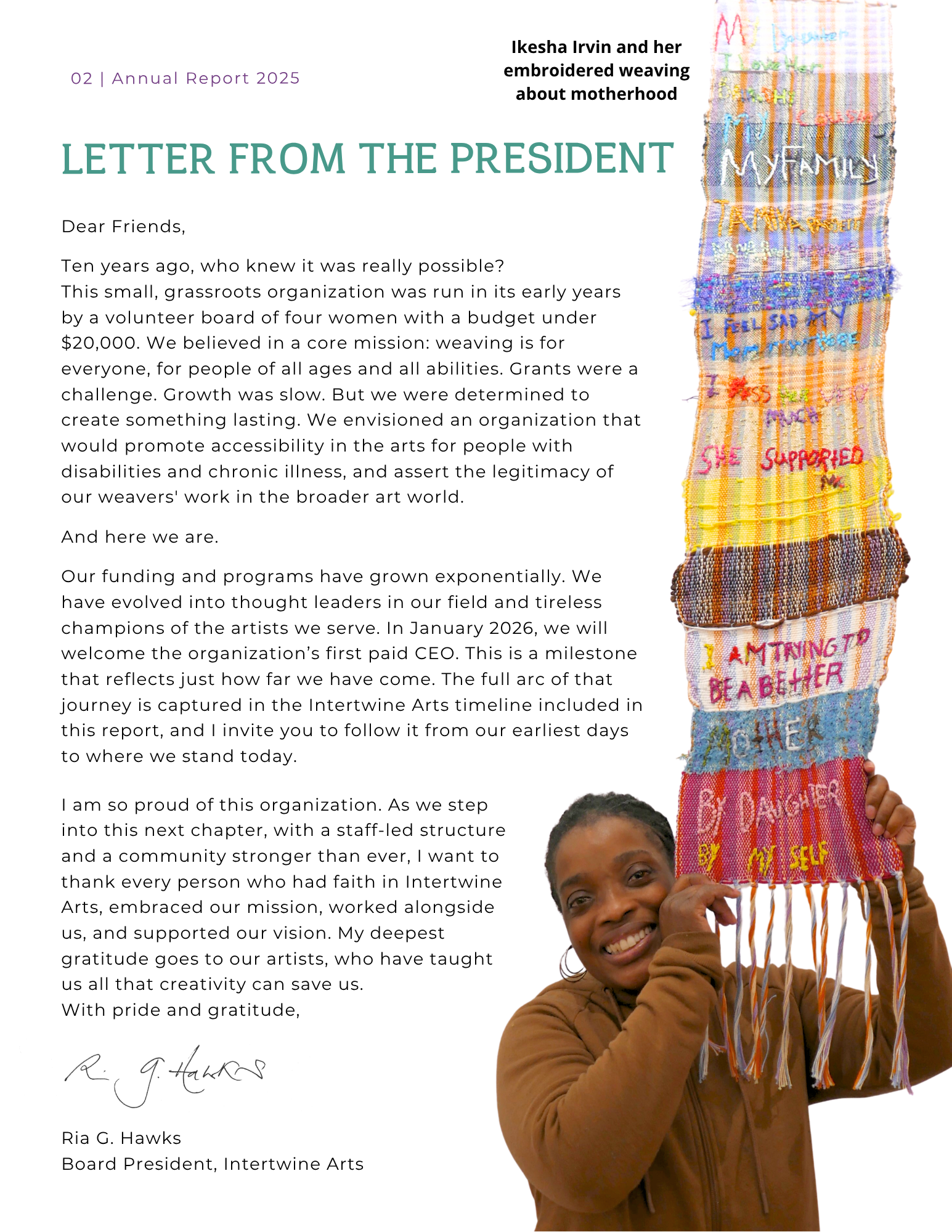 A woman smiling and holding a colorful embroidered woven banner with various words and messages about motherhood and empowerment, including phrases like 'I am trying to be a better mother by myself' and 'supporting my daughters.'