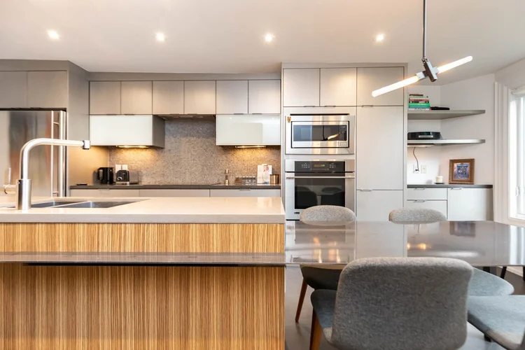 Victorian home kitchen renovation in Toronto by First Place Homes: walnut island and grey cabinetry