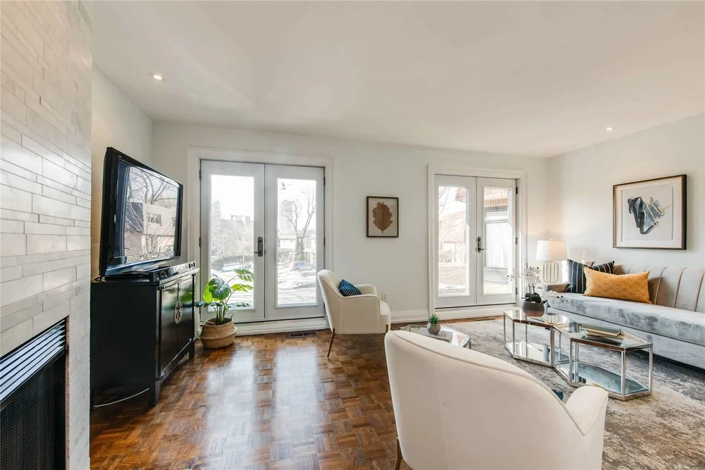 North Central Toronto living room by First Place Homes: fireplace and French doors to the garden