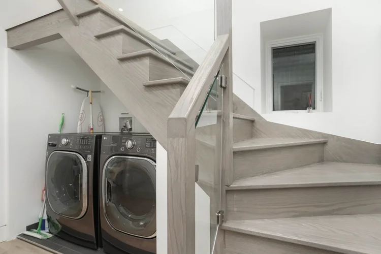 Laundry beside a new stair in the High Park home renovation by First Place Homes