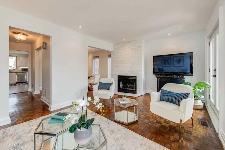 North Central Toronto home renovation by First Place Homes: living room with a fireplace and wood floors