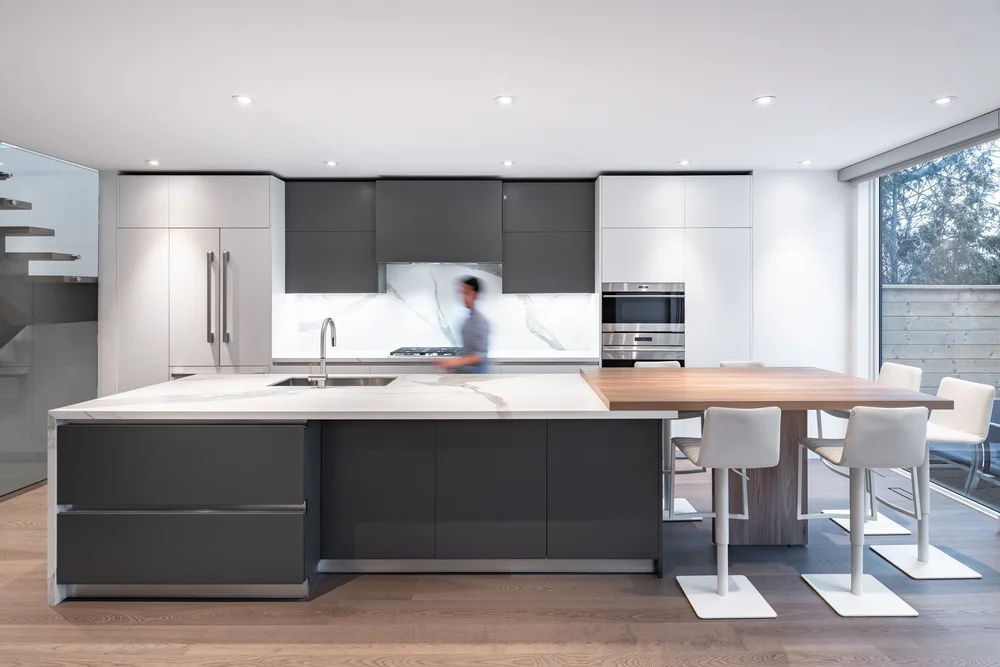 West side Toronto kitchen by First Place Homes: island with seating and dark cabinets