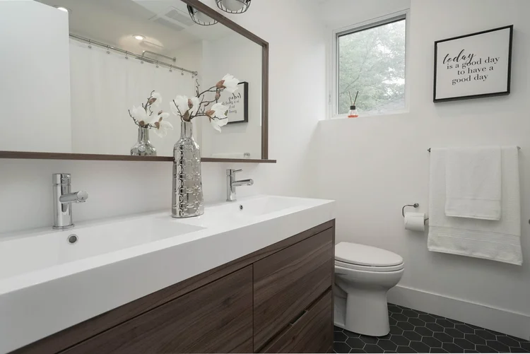 High Park bathroom renovation by First Place Homes: double sink vanity with a wide mirror